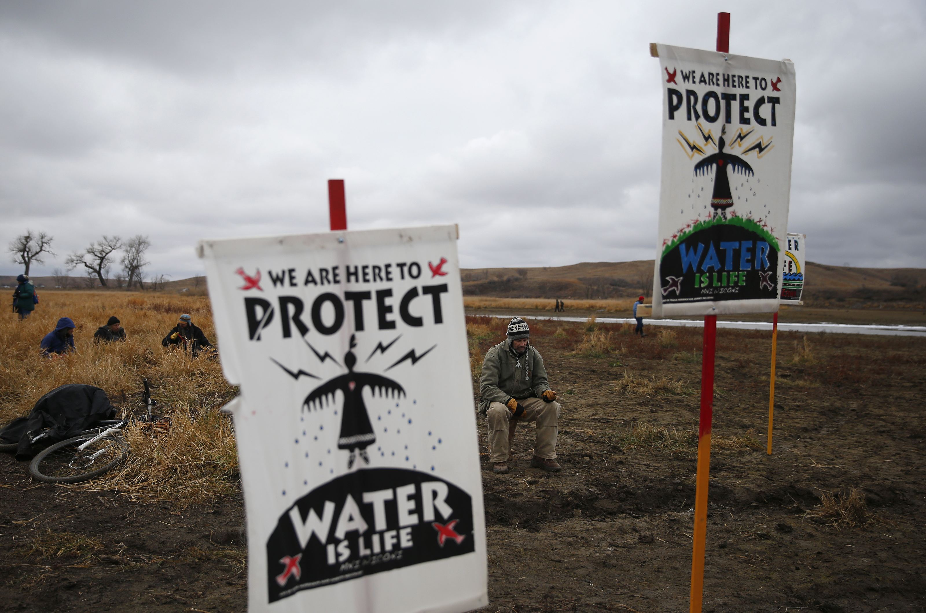 Water protectors protest as police line the hill at Standing Rock on Nov. 24, 2016, during an ongoing dispute over the building of the Dakota Access Pipeline. (Jessica Rinaldi&mdash;Boston Globe/etty Images)