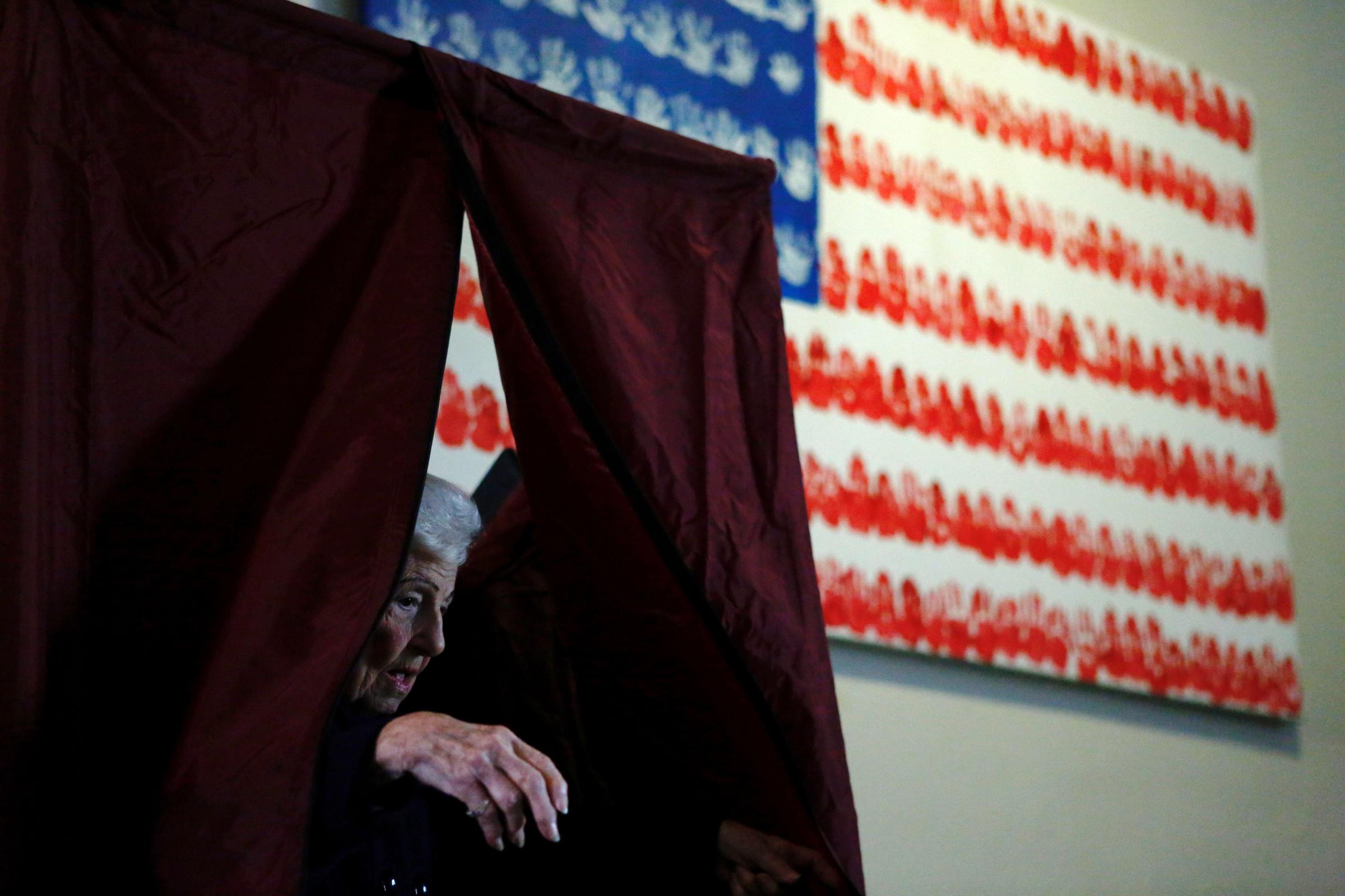 A woman exits a polling station after voting in the presidential election in Newport, New Jersey.
