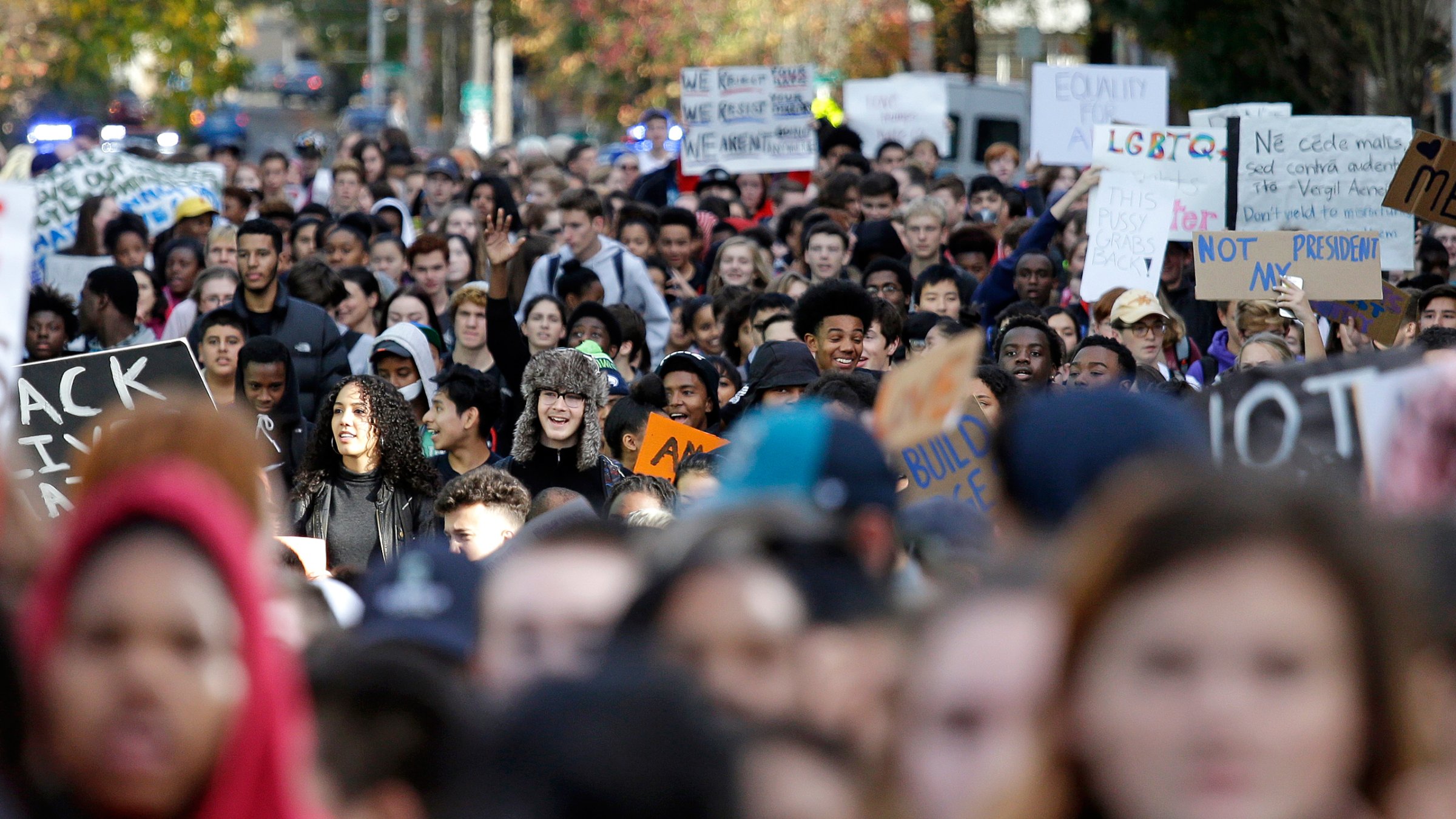 High school students fill a street as they head to join others during a walkout to protest the election of Donald Trump as president, Monday, Nov. 14, 2016, in Seattle. A spokesman with Seattle Public Schools estimates that about 2,300 students from 14 middle and high schools participated in the walkout and said that students who walk out of class will get an "unexcused absence." (AP Photo/Elaine Thompson)