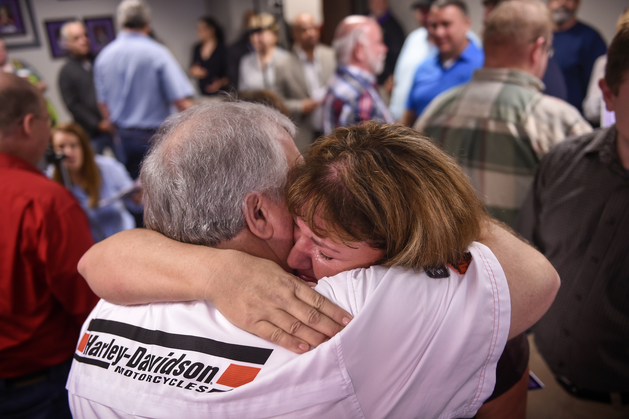 Amy O'Neal cries as she hugs co-worker and fellow lottery winner Larry Estes at the Tennessee Lottery Headquarters in Nashville, on Nov. 29, 2016. in Nashville. (Lacy Atkins—The Tennessean/AP)