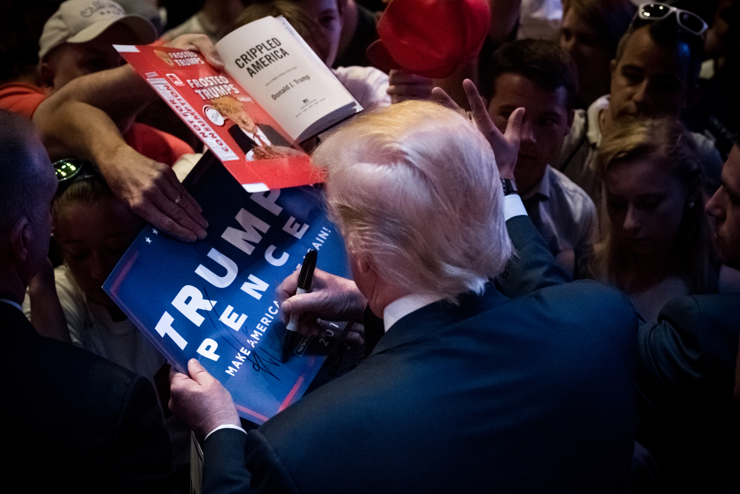 Donald J. Trump signs memorabilia while campaigning in Portland, Maine, on Aug. 4, 2016. (Monica Jorge—Sipa USA/AP)