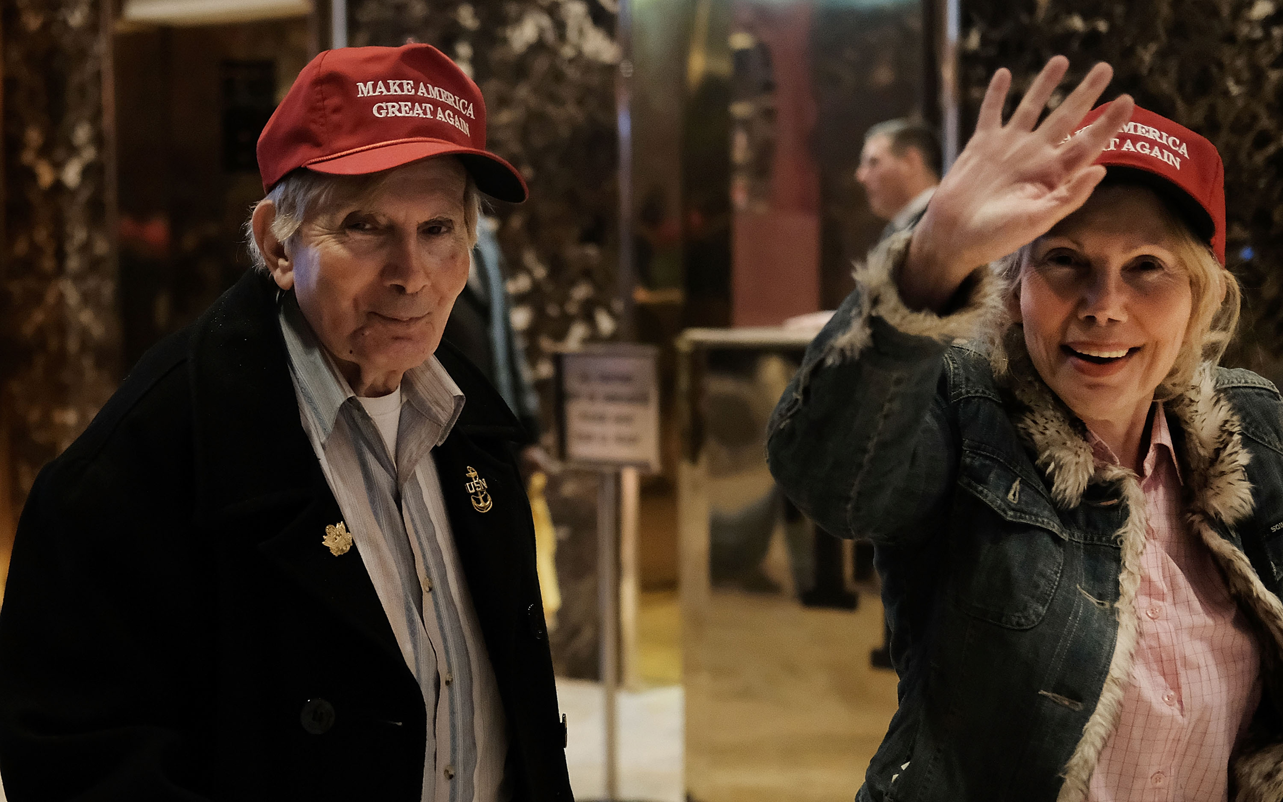 Donald Trump supporters walk through the lobby of Trump Tower as the media congregates in the lobby on Nov. 18, 2016.