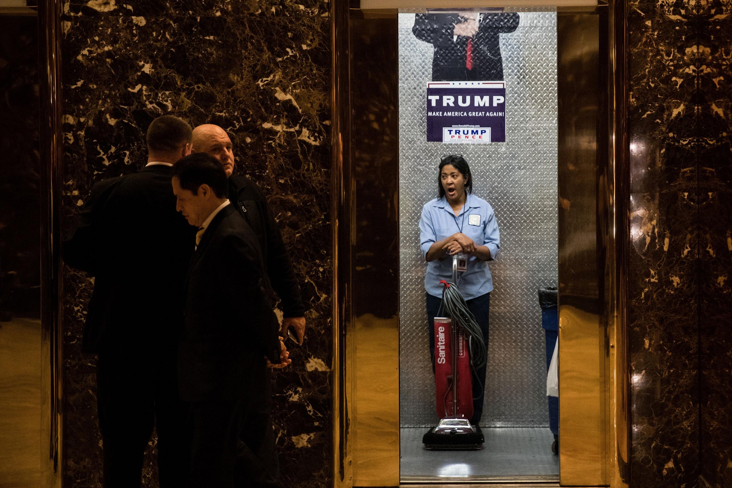 A maintenance worker yawns as she stands in an elevator in the lobby at Trump Tower, on Nov. 14, 2016.