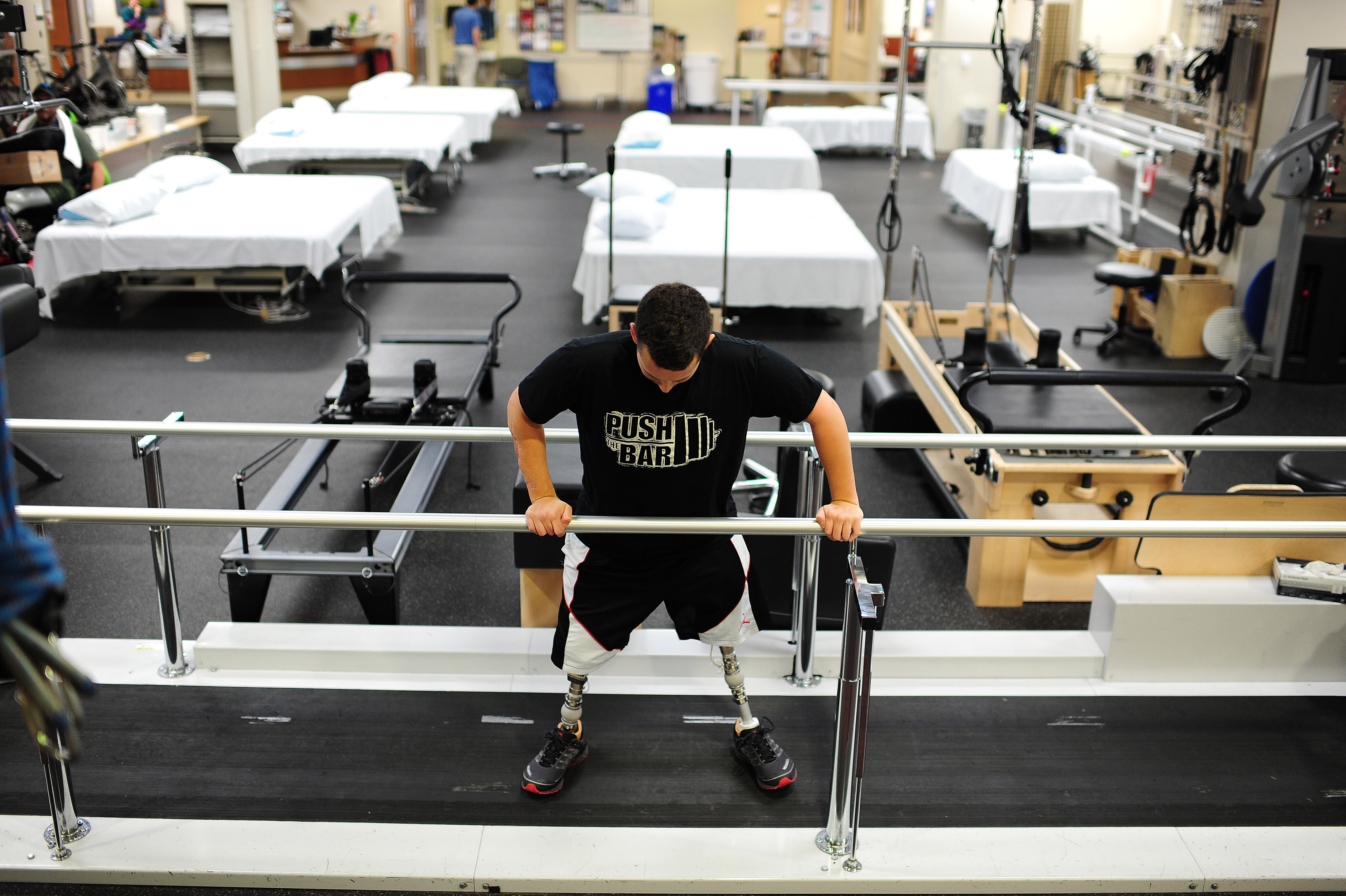 U.S. Army Staff Sgt. Sam Shockley works on his balancing and walking with prosthetic legs as he rehabs at Walter Reed National Military Medical Center on Friday May 09, 2014 in Bethesda, MD.  The center plays a crucial role in rehabbing those who suffered traumatic injuries. (Matt McClain—The Washington Post/Getty Images)
