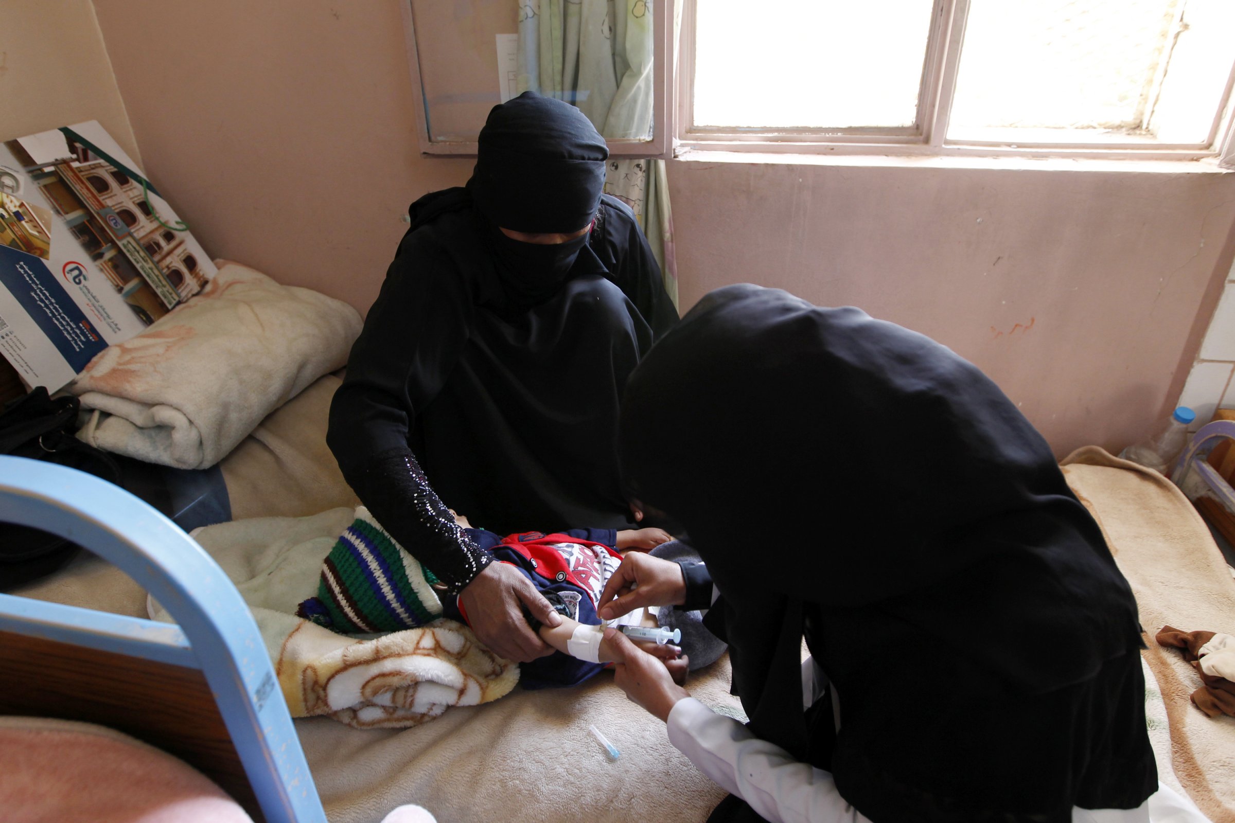 A Yemeni doctor injects a baby at a Kuwaiti hospital on November 6, 2016 in the Yemeni capital Sanaa.