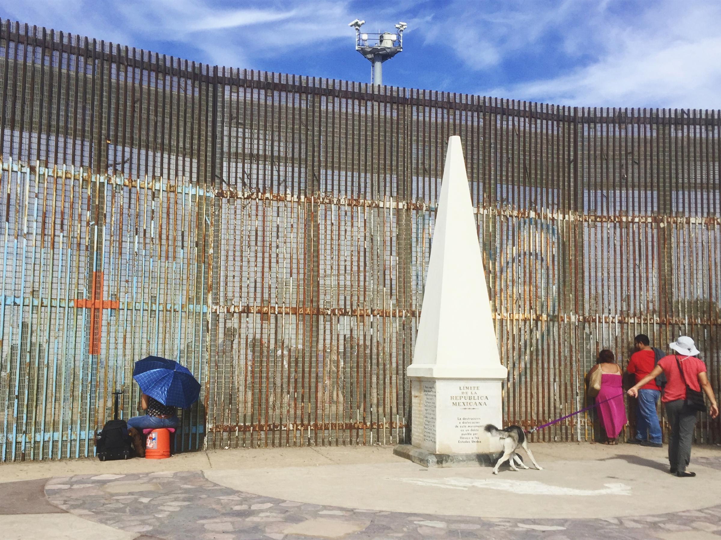 People connecting with their loved ones through the border fence in Tijuana on the U.S.-Mexico border by the last border monument under the U.S. surveillance cameras. Nov. 2016.