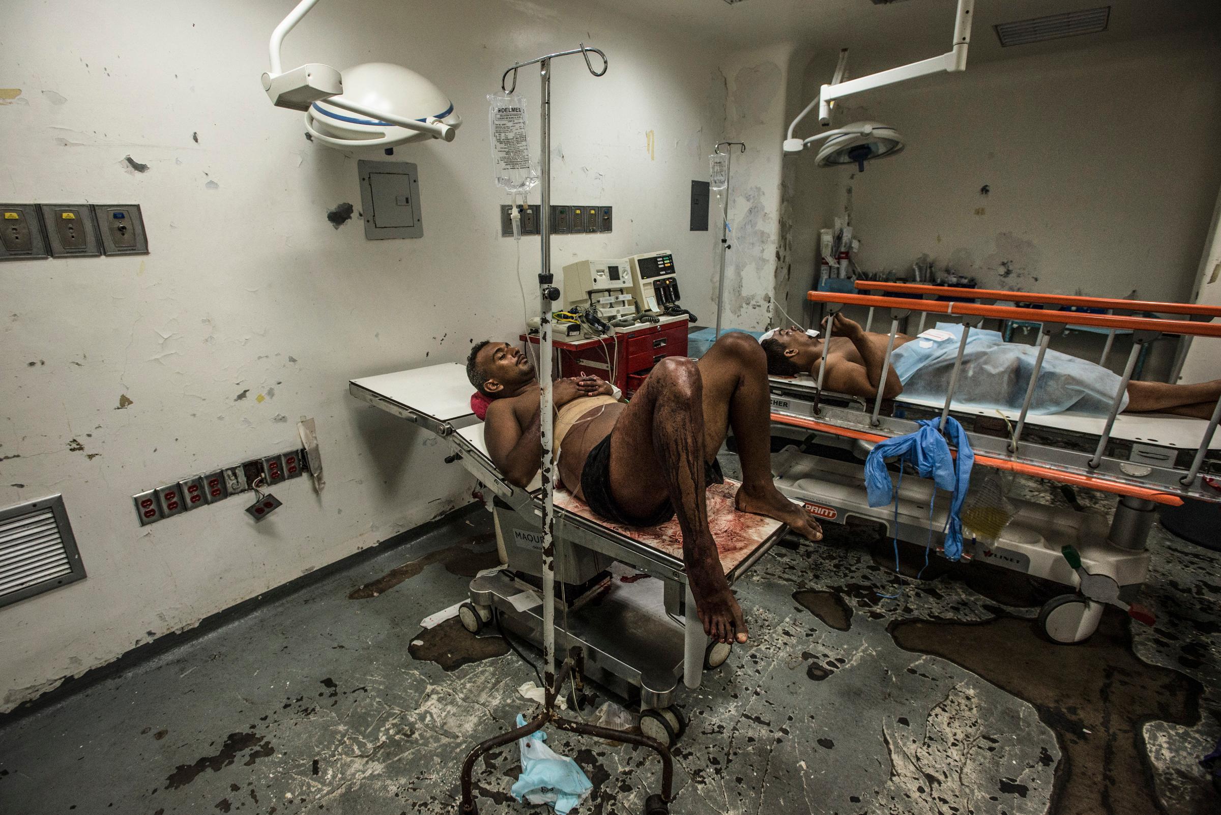 Jose Villarroel waits for hours in an emergency operating room at Luis Razetti Hospital.
