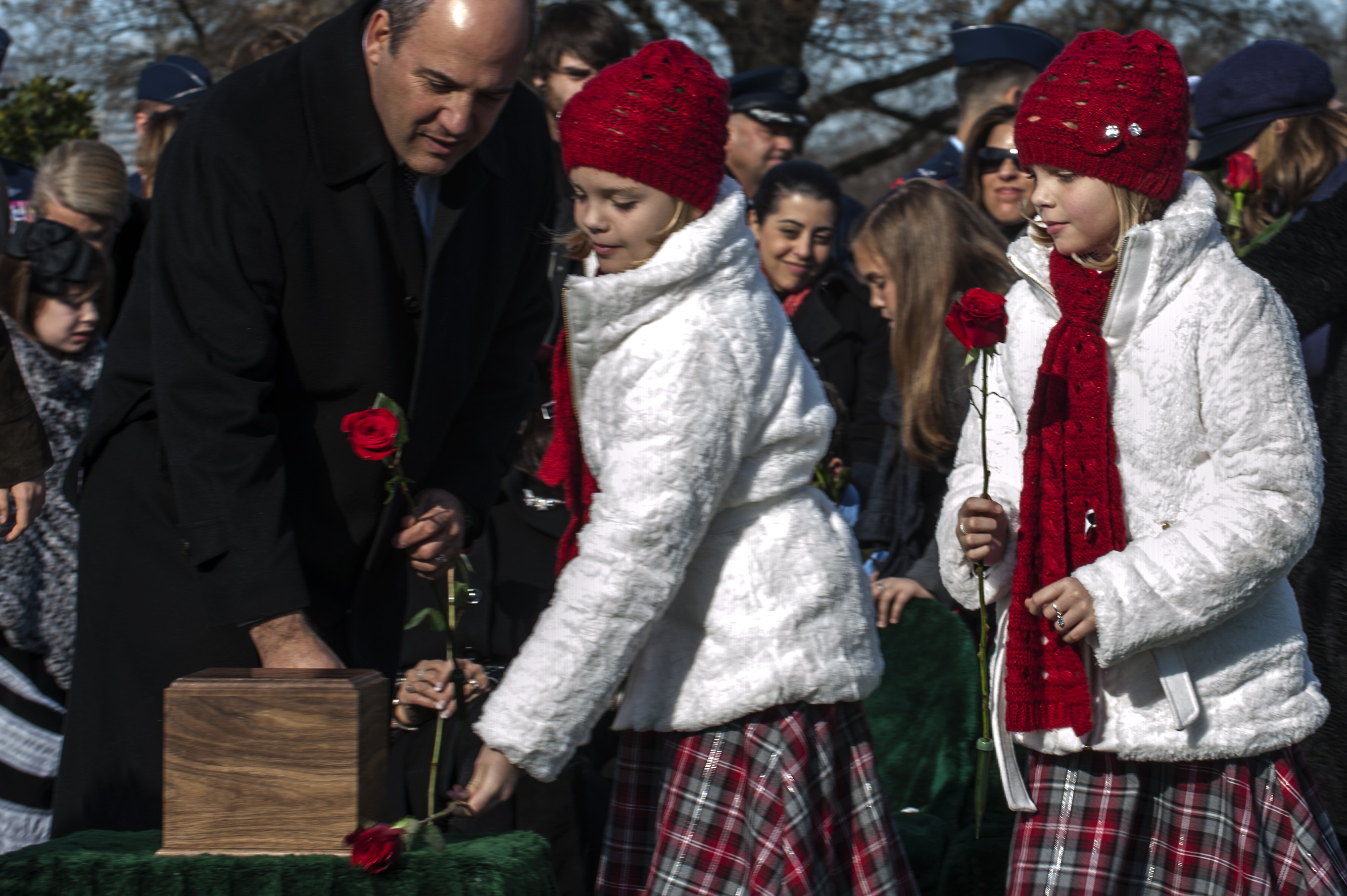 Dec. 11, 2013. Aspen and Annalise Gilbert Ravella remember their father at his second Arlington burial. (Air Force photo / Carlin Leslie—)