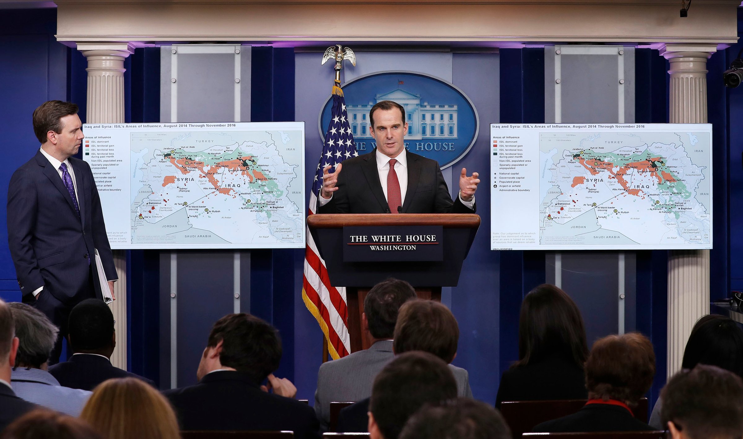 Brett McGurk, White House envoy to the U.S.-led military coalition against the Islamic State group, joined by White House press secretary Josh Earnest, left, speaks about the conflict in Syria during the daily news briefing at the White House in Washington, on Dec. 13, 2016.
