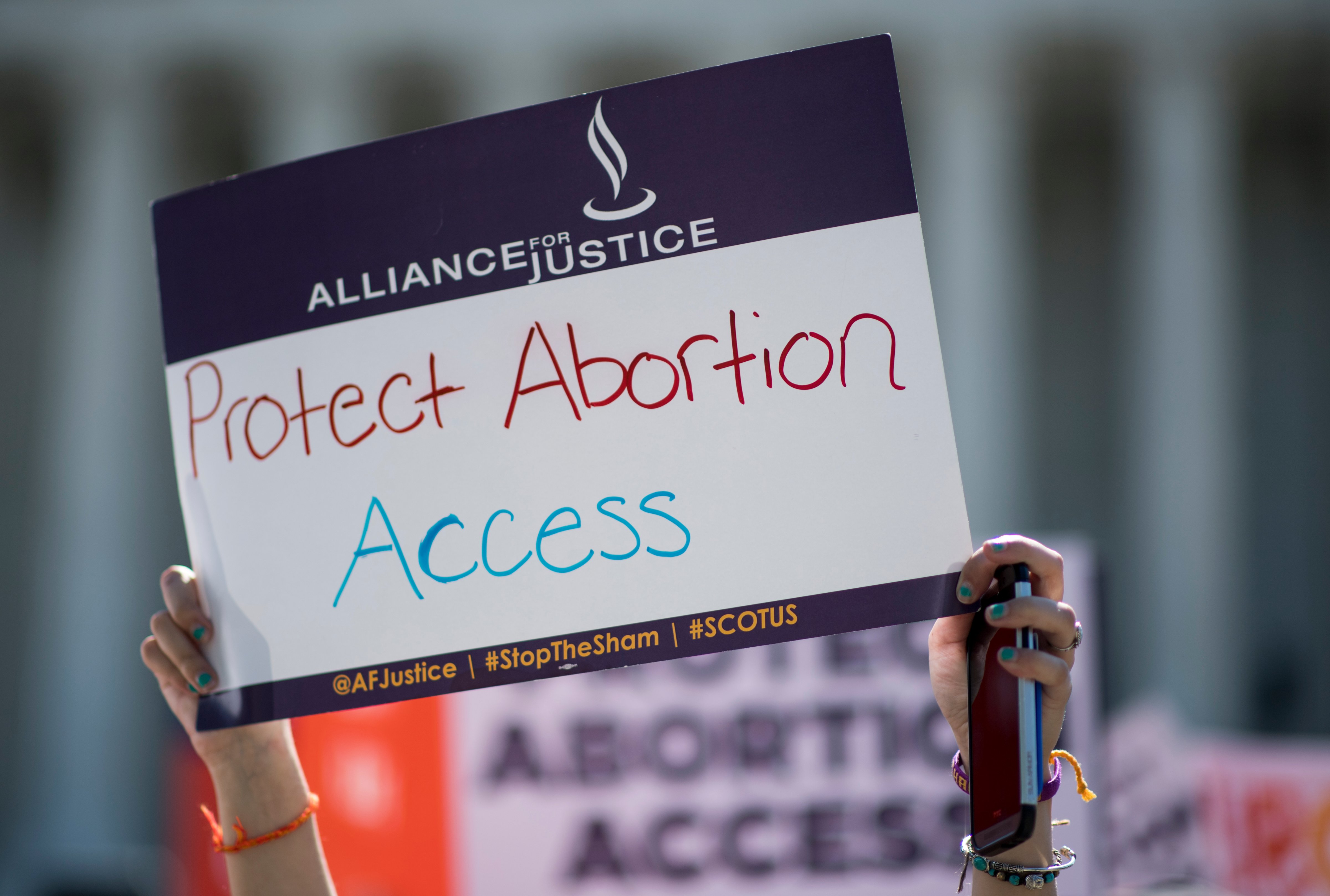 UNITED STATES - JUNE 20: Pro-choice and pro-life demonstrators rally outside of the U.S. Supreme Court on Monday morning, June 20, 2016. The court is expected to hand down their decision on a Texas law which requires clinics to meet the same standards as ambulatory surgical centers and forces doctors to have admitting privileges at nearby hospitals. (Photo By Bill Clark/CQ Roll Call) (Bill Clark—CQ-Roll Call,Inc.)
