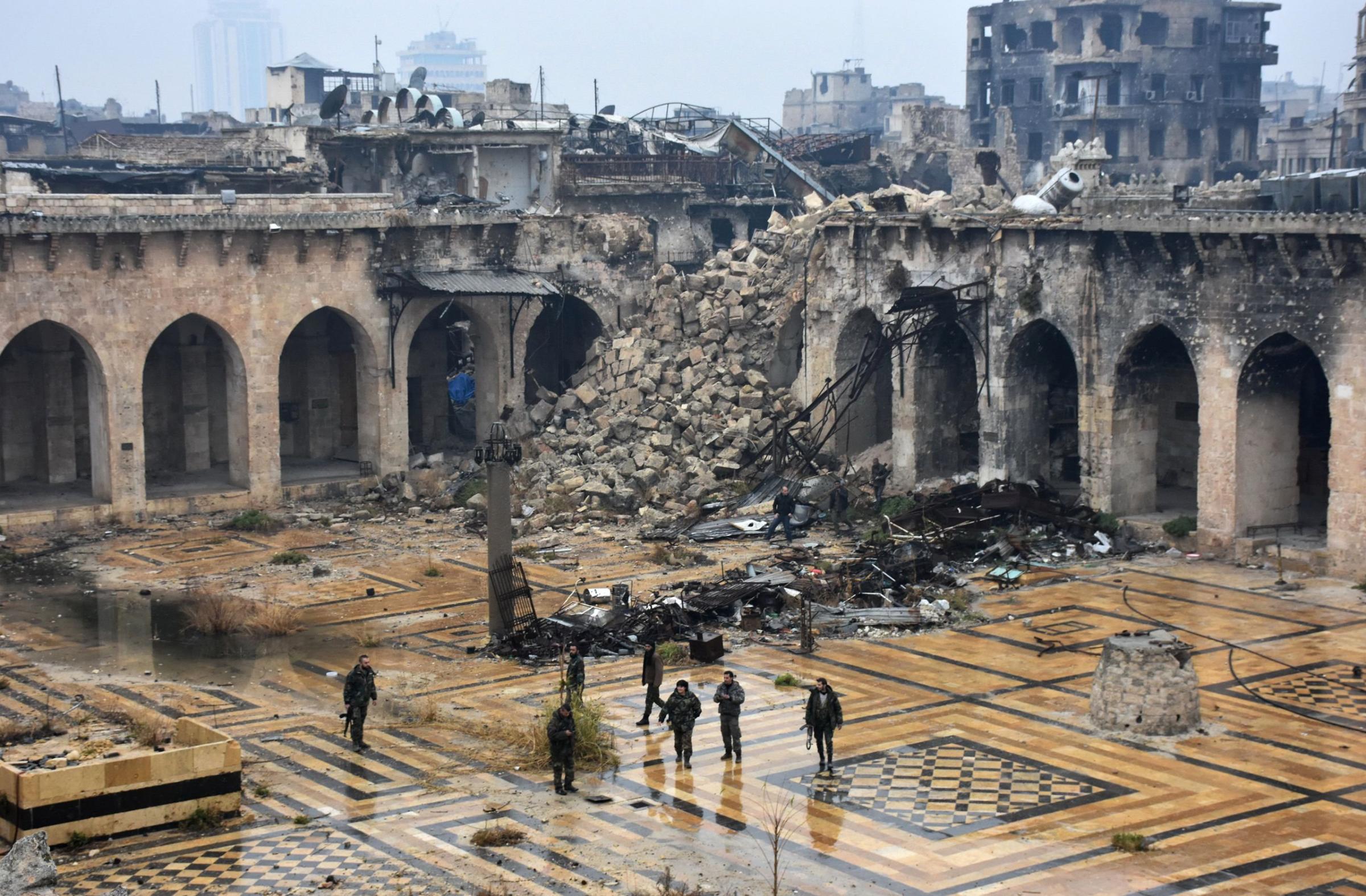 Syrian pro-government forces walk in the ancient Umayyad mosque in Aleppo after they captured the area on Dec. 13, 2016.