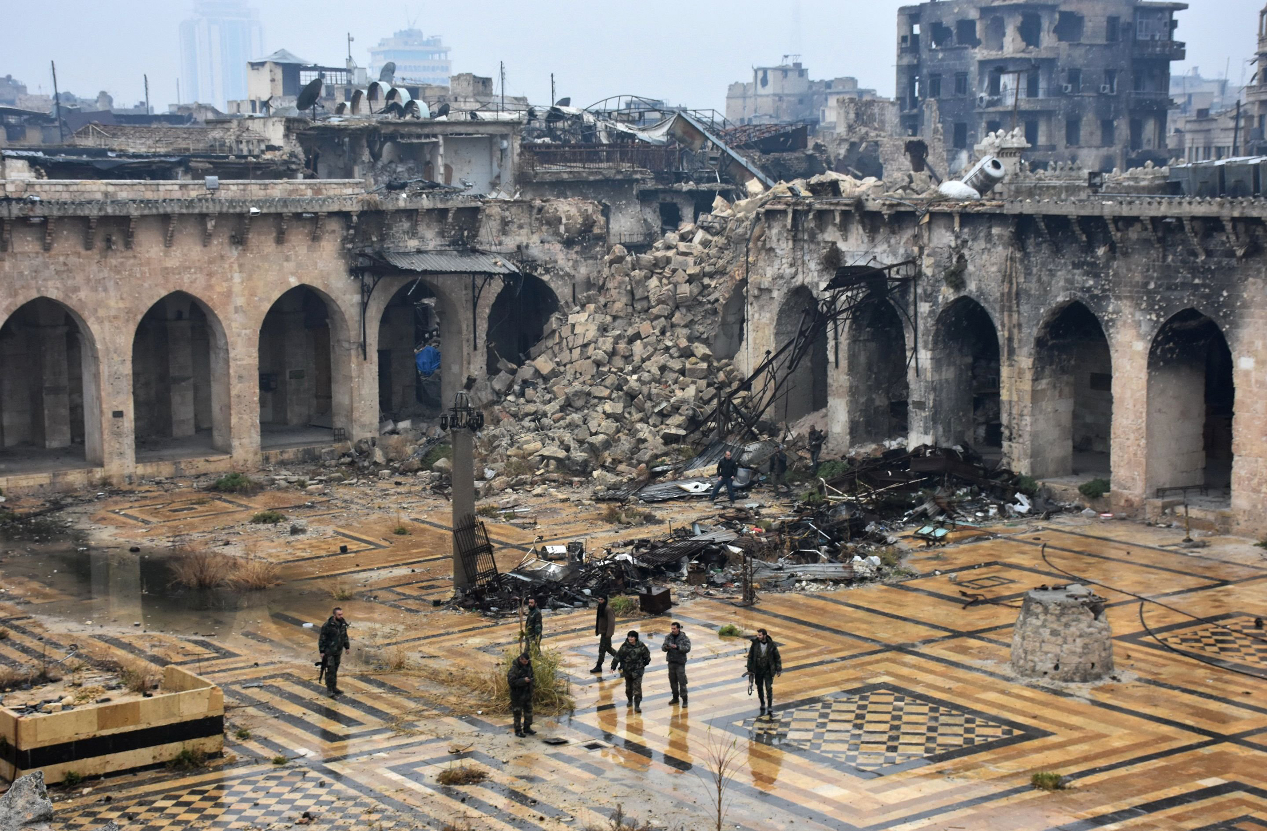 Syrian pro-government forces walk in the ancient Umayyad mosque in Aleppo after they captured the area on Dec. 13, 2016. (George Ourfalian—AFP/Getty Images)