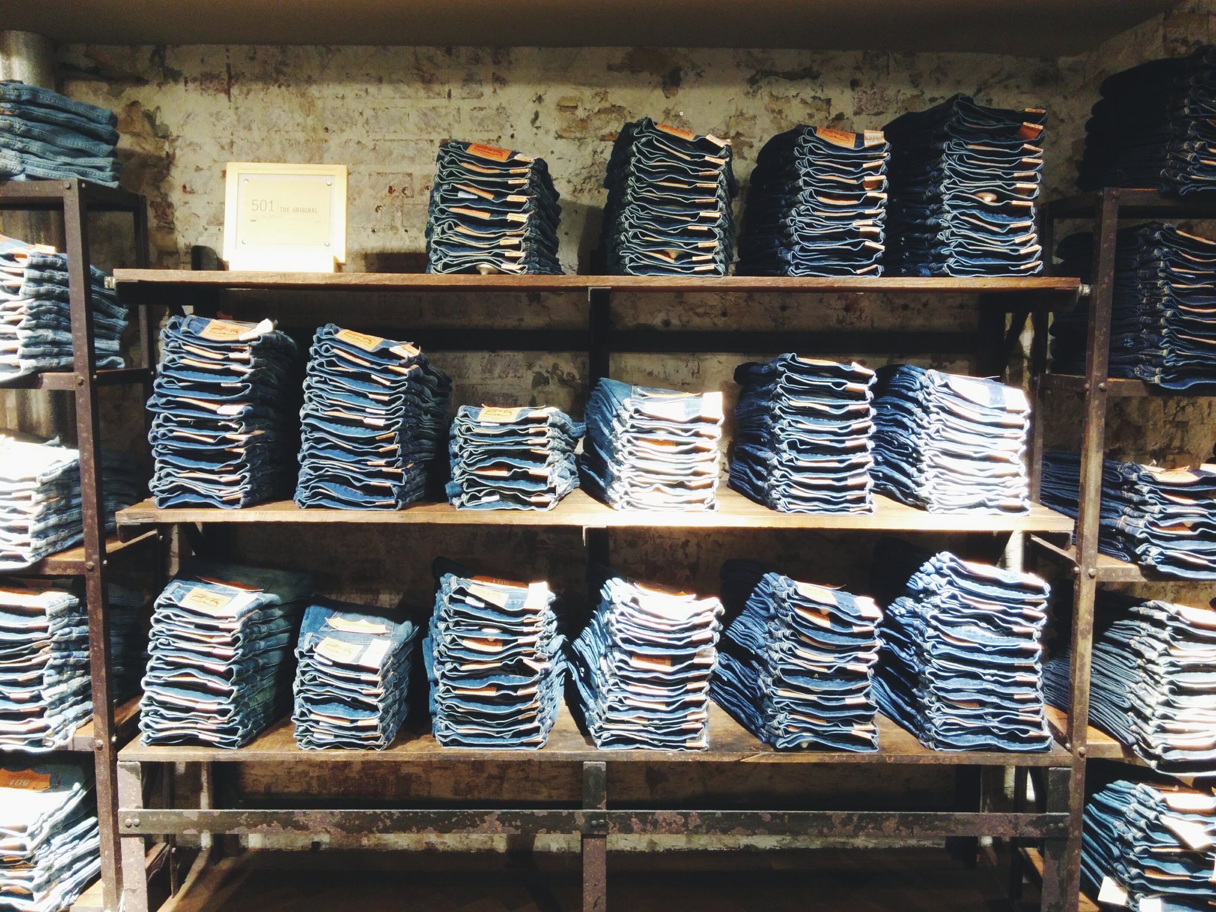 Folded Jeans Kept On Shelves In Shop