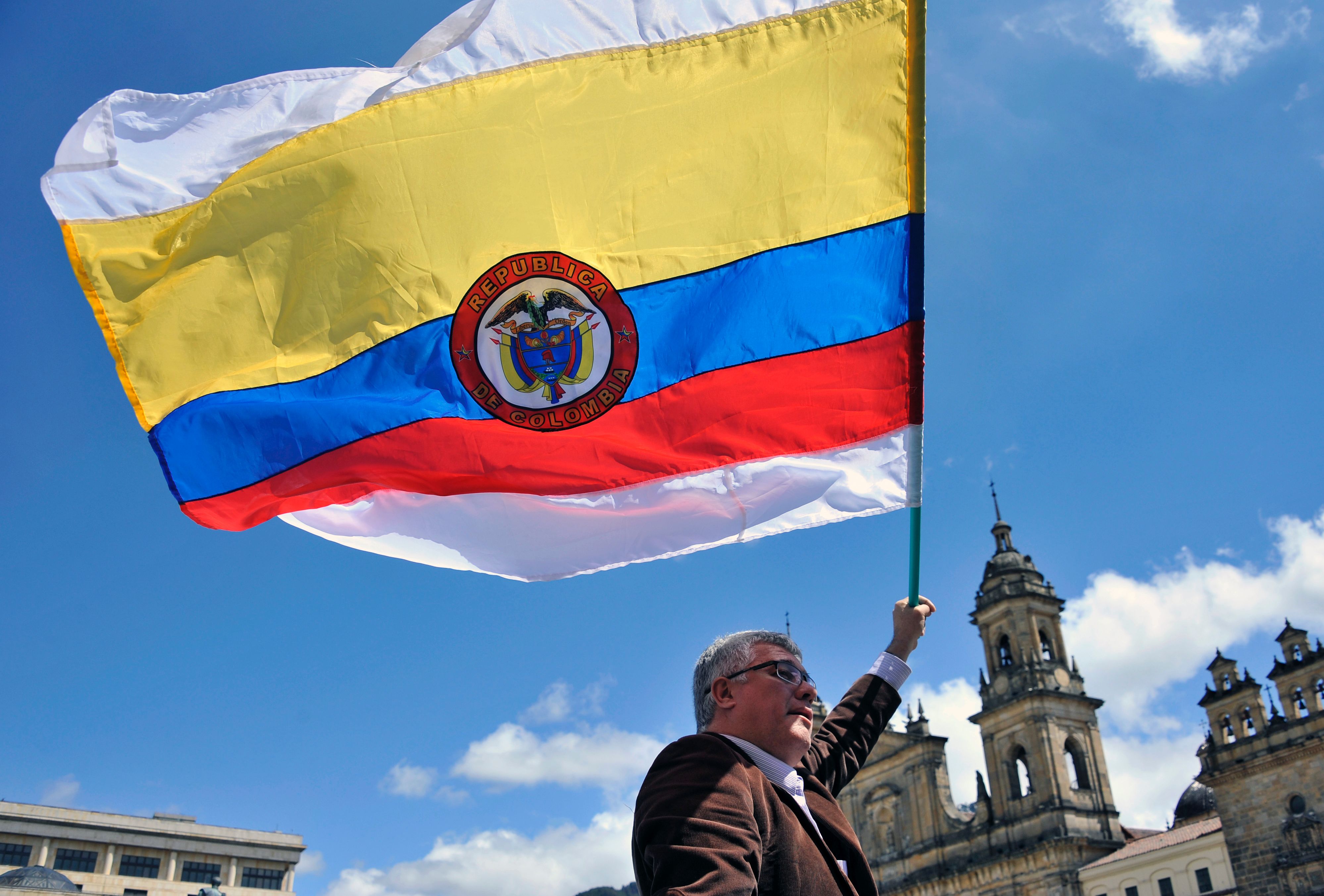 A man holds a Colombian national flag with white stripes during a demo to demand the immediate endorsement of the new peace agreement between the Colombian government and the FARC guerrilla outside the Colombian Congress in Bogota, on November 30, 2016. (GUILLERMO LEGARIA—AFP/Getty Images)