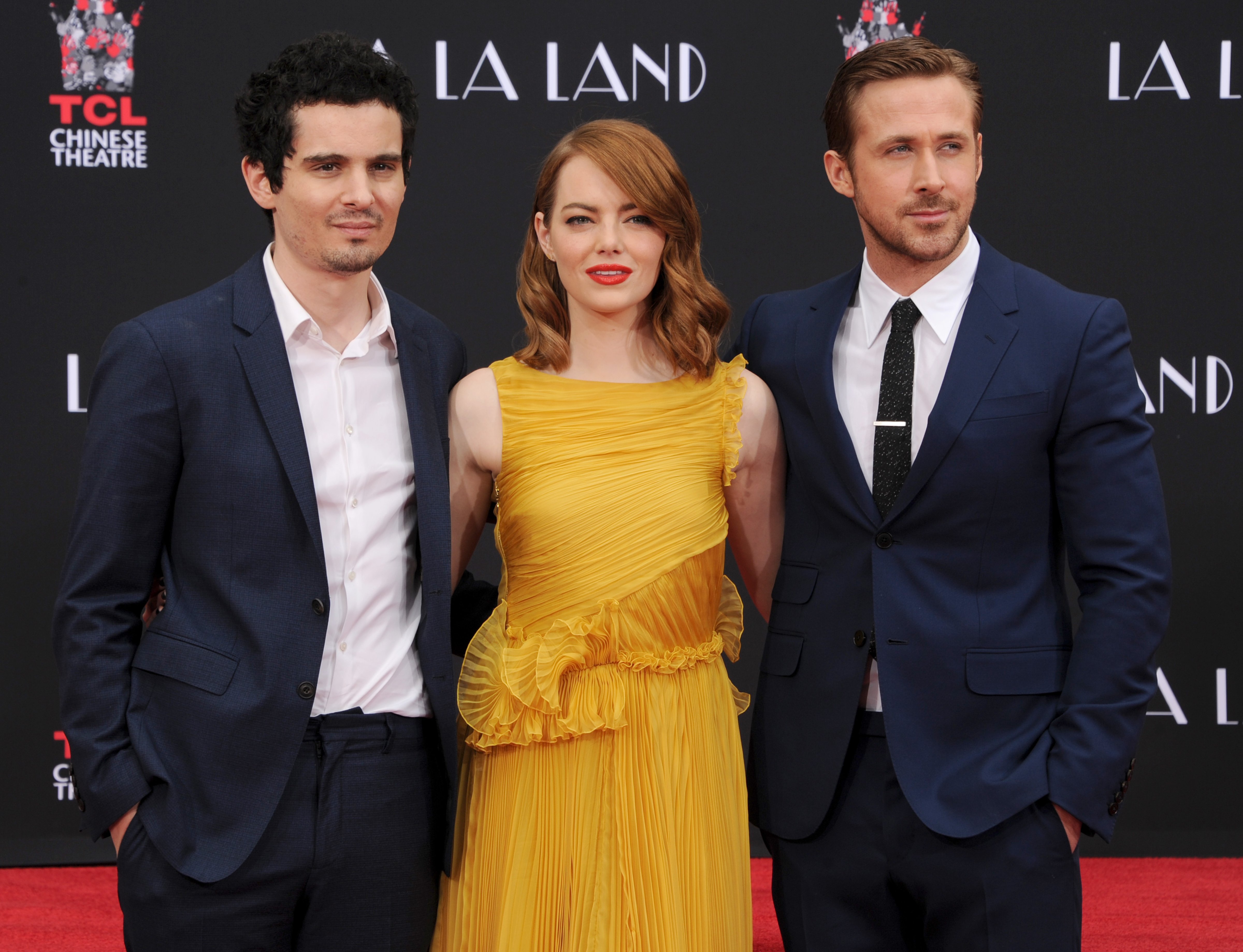 Director Damien Chazelle (L) and actors Emma Stone and Ryan Gosling who are honored with a Hand and Footprint Ceremony at TCL Chinese Theatre IMAX on behalf of Lionsgate's LA LA LAND on December 7, 2016. (Gregg DeGuire&mdash;Getty Images)
