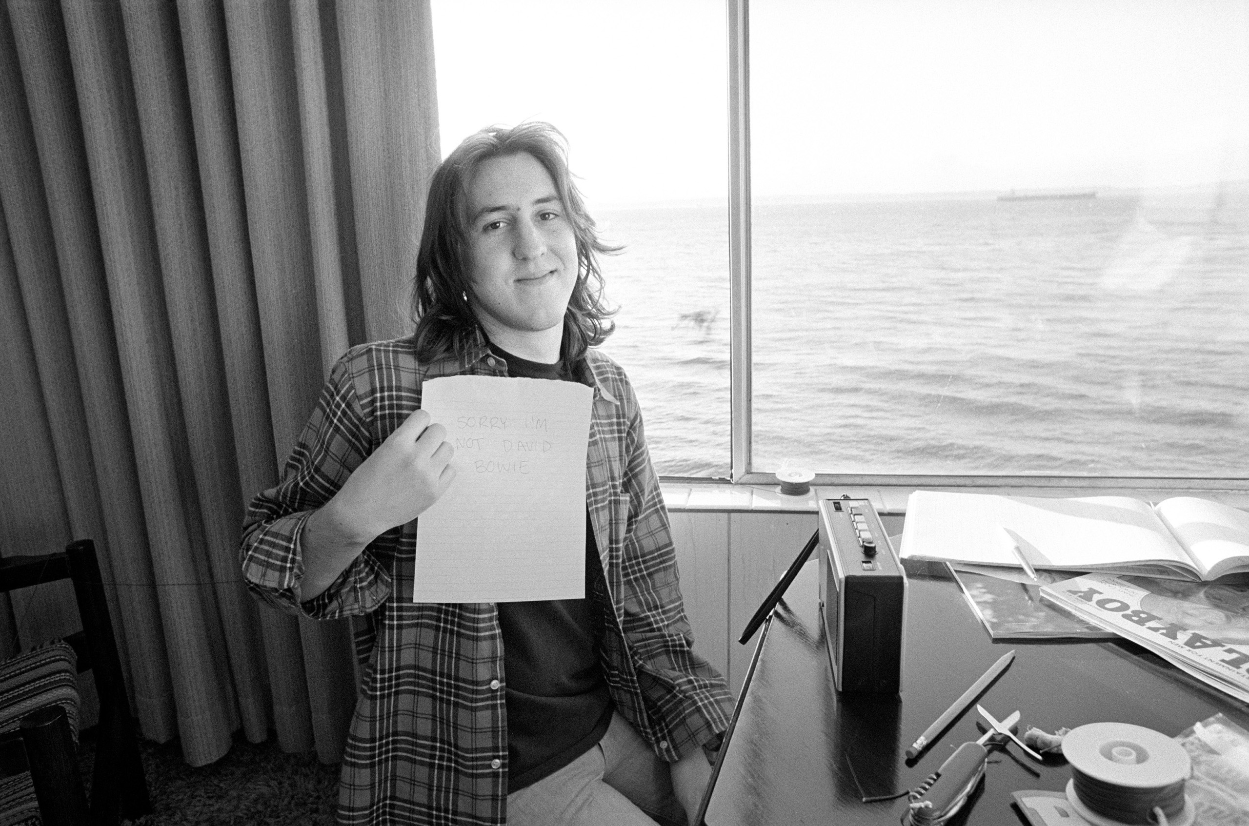 Rolling Stone magazine's 18 year old reporter Cameron Crowe holds a sign he wrote stating,   Sorry I'm not David Bowie . He created the sign for the fans that were attempting to access their icon at the hotel in Seattle.