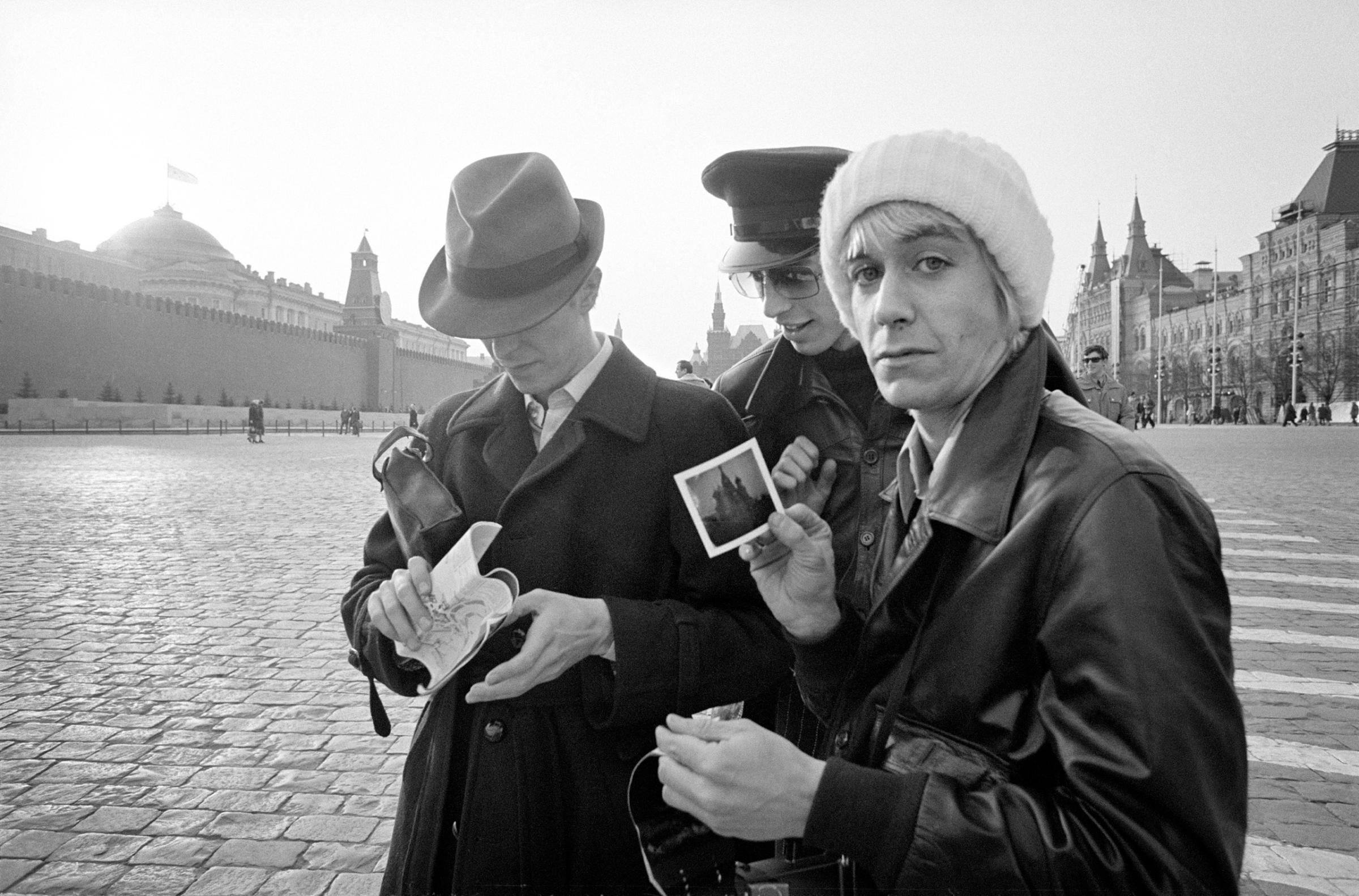 Iggy Pop flashes a Polaroid he'd just taken in Moscow's Red Square. Bowie and his tour manager, Pat Gibbons, are in the background.