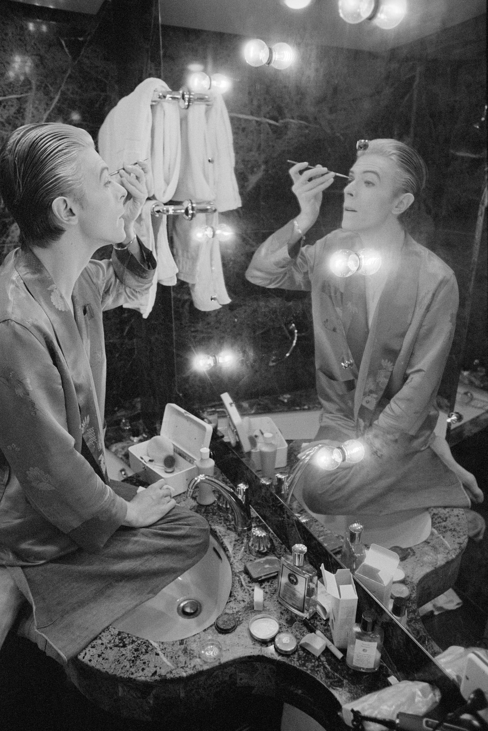 Bowie prepares his makeup in his Paris hotel suite prior to an impromptu photo. shoot.