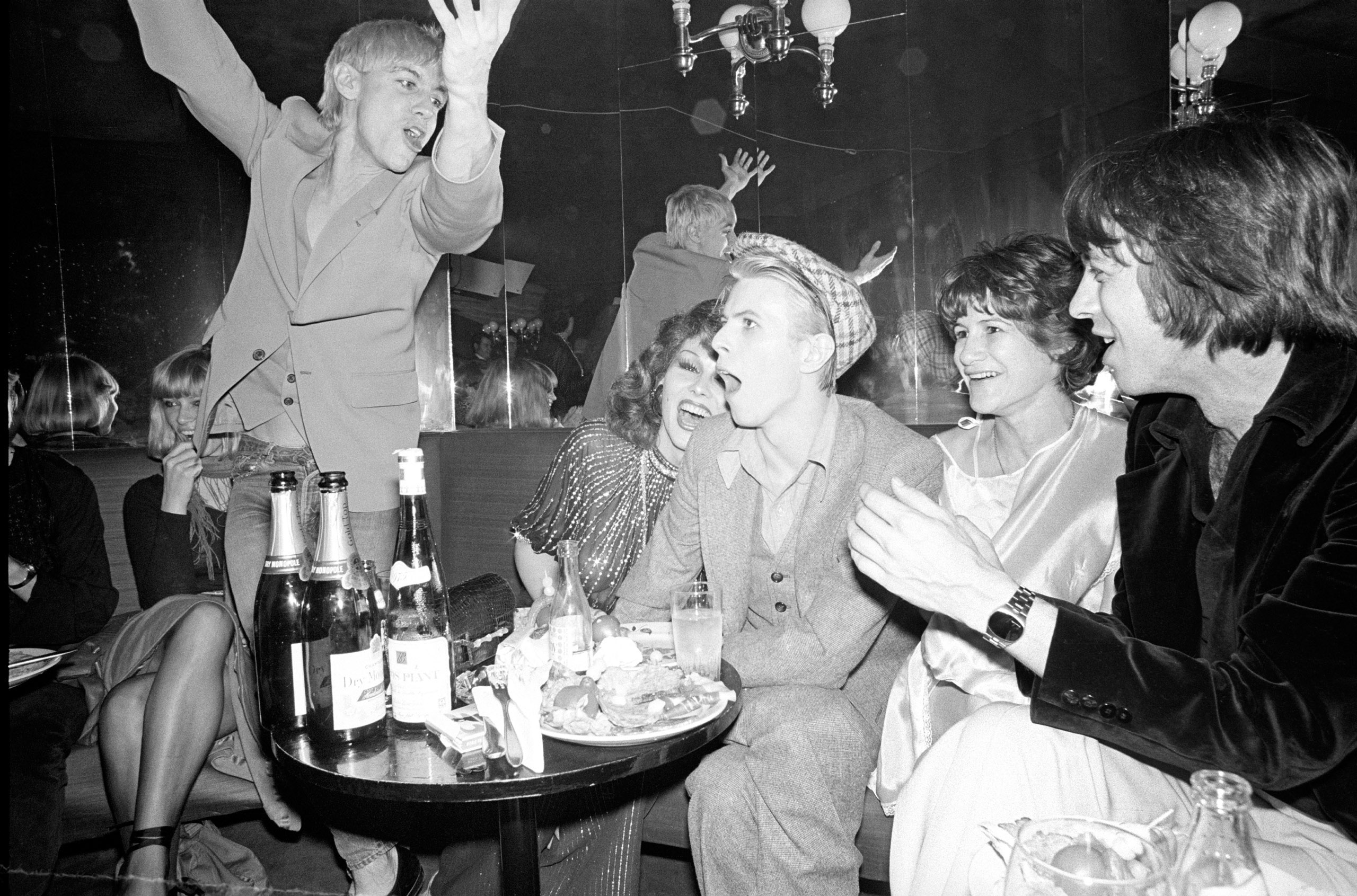 Bowie celebrates his birthday and the end of the Isolar tour at L’ange Bleu in Paris with (from left to right) Iggy Pop, Romy Haag, Coco Schwab, and Pat Gibbons.