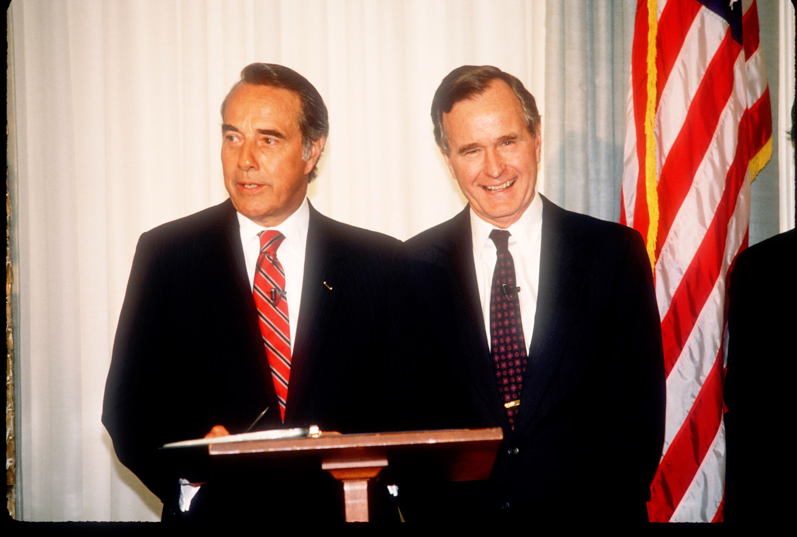 George Herbert Walker Bush stands with Bob Dole in Washington, D.C., on April 15, 1988. (Cynthia Johnson—Liaison/Getty Images)