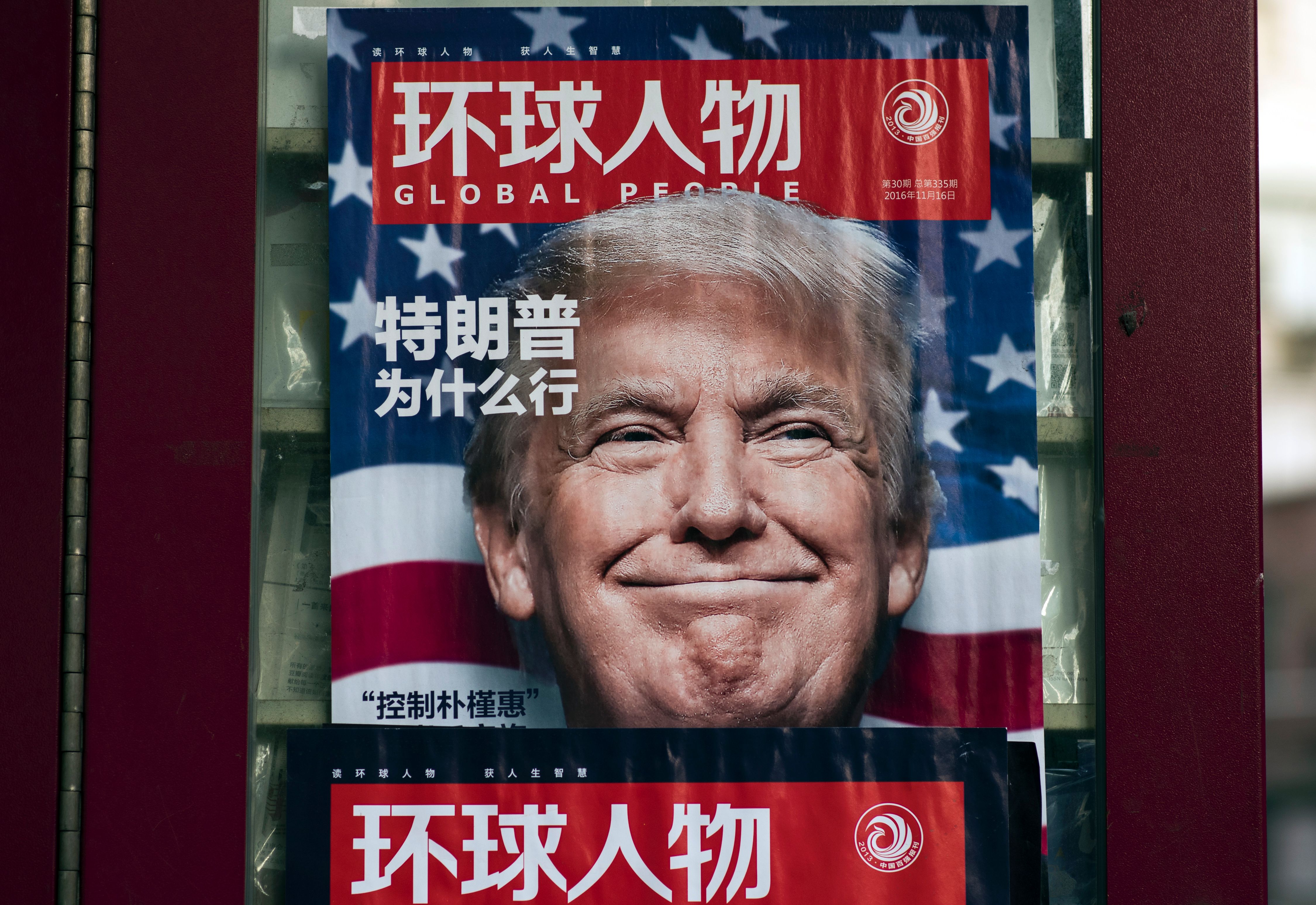 An advertisement for a magazine featuring U.S. President-elect Donald Trump on the cover at a news stand in Shanghai on December 14, 2016. (Johannes Eisele—AFP/Getty Images)
