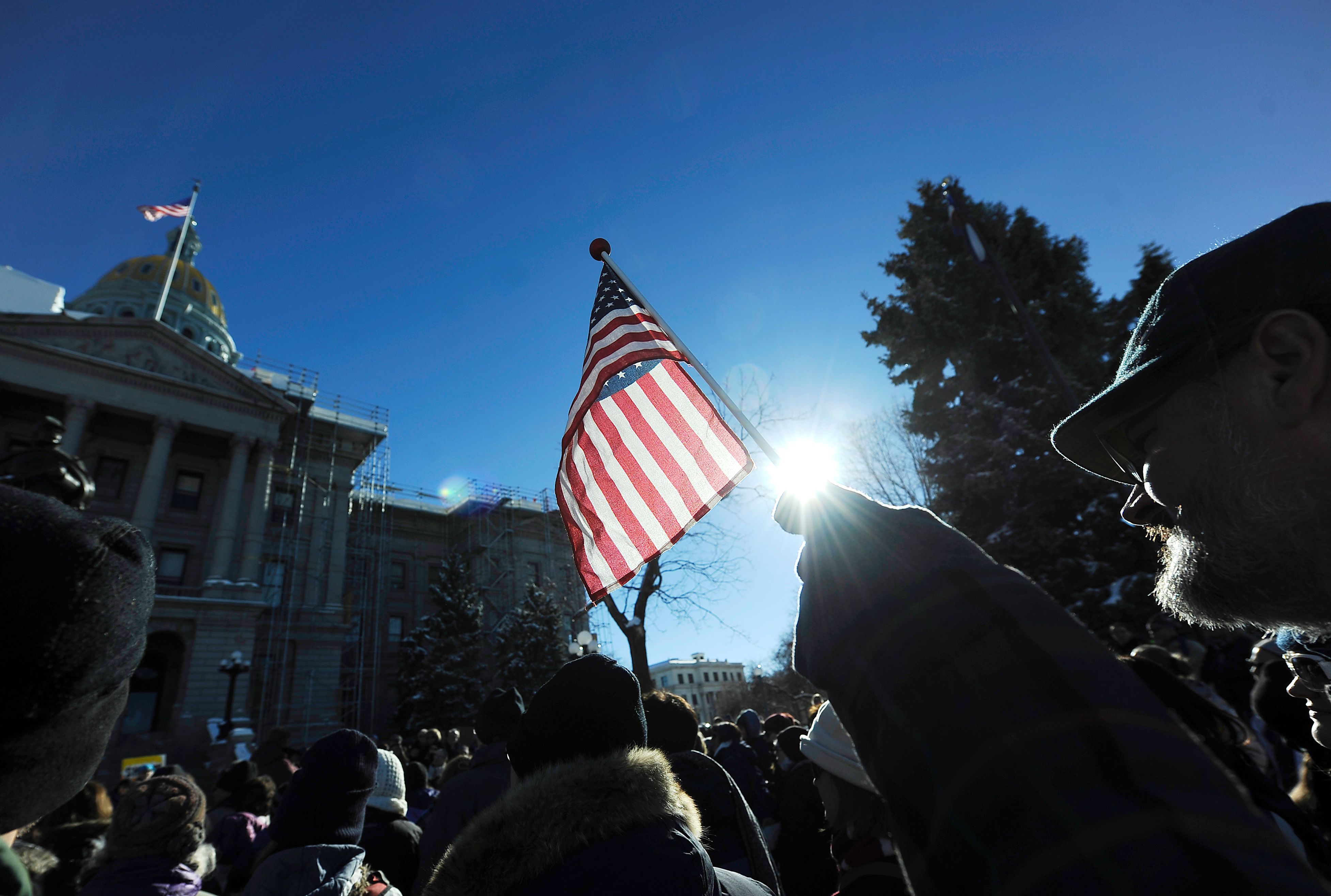 A demonstrator holds a flag during a protest outside the Colorado Capitol building in Denver, Colorado on December 19, 2016 to demonstrate against U.S. President-elect Donald Trump on the day the Electoral College votes to certify the election. (Chris Schneider—AFP/Getty Images)