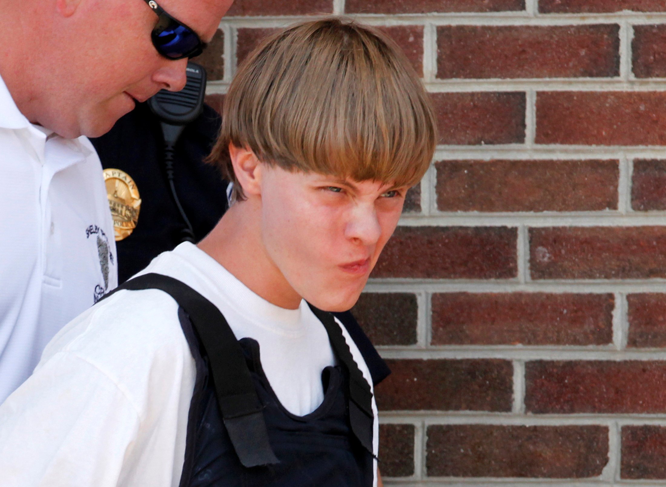 File photo of police leading suspected shooter Dylann Roof into the courthouse in Shelby