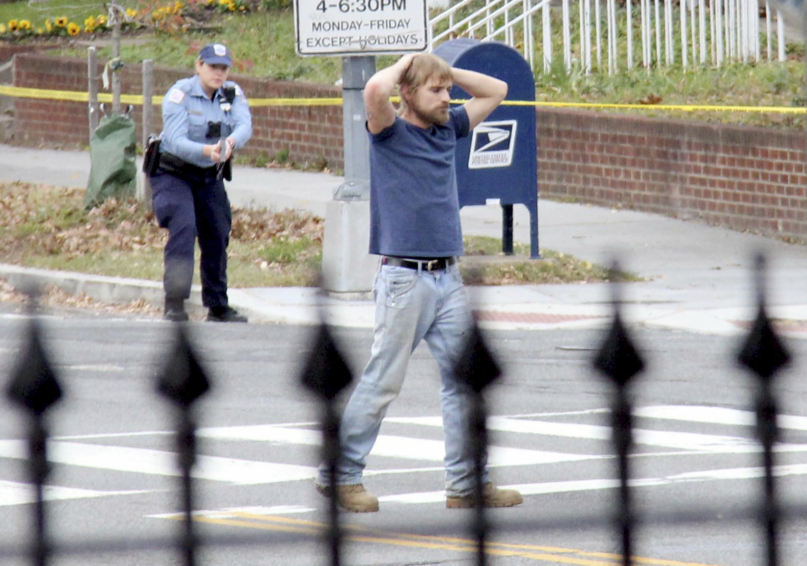 Edgar Maddison Welch, 28 of Salisbury, N.C., surrenders to police Dec. 4, 2016, in Washington D.C. after firing a gun while claiming to investigate a conspiracy theory about Hillary Clinton running a child sex ring. (Sathi Soma—AP)