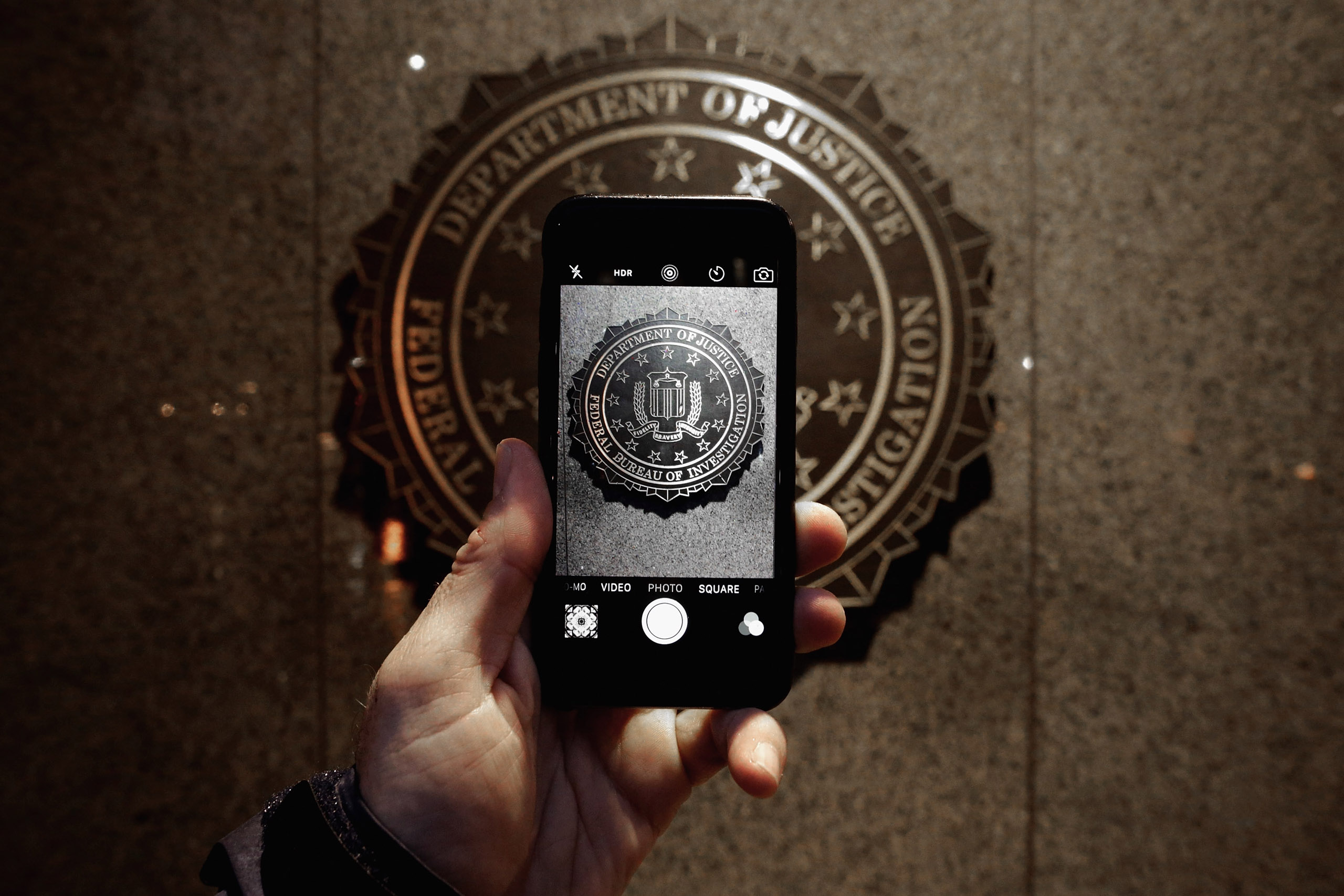 The official seal of the Federal Bureau of Investigation is seen on an iPhone's camera screen outside the J. Edgar Hoover headquarters in Washington, DC, on Feb. 23, 2016. (Chip Somodevilla—Getty Images)