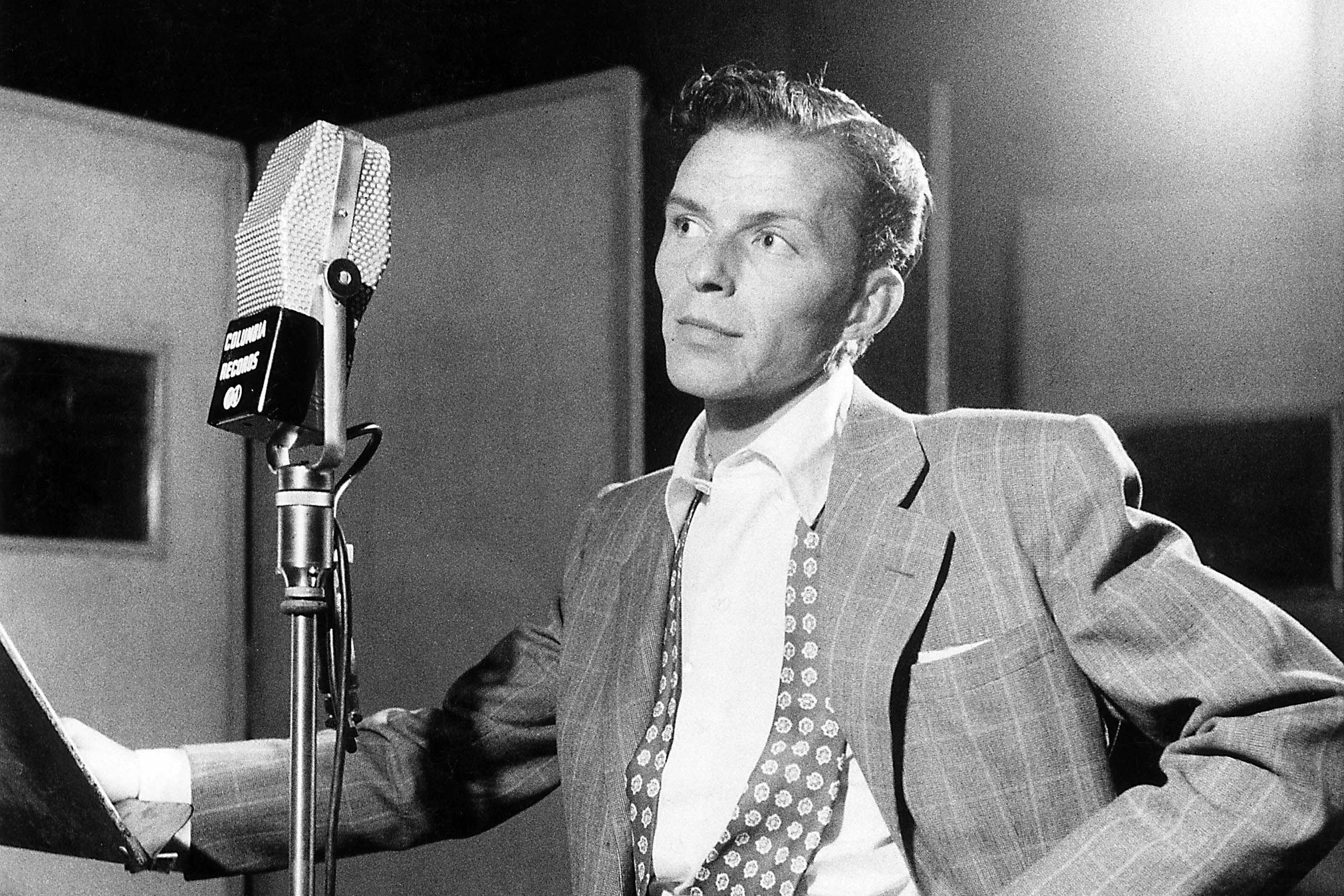 Frank Sinatra next to microphone recording at Columbia Recording studios, Liederkrantz Hall. (William Gottlieb—Redferns/Getty Images)