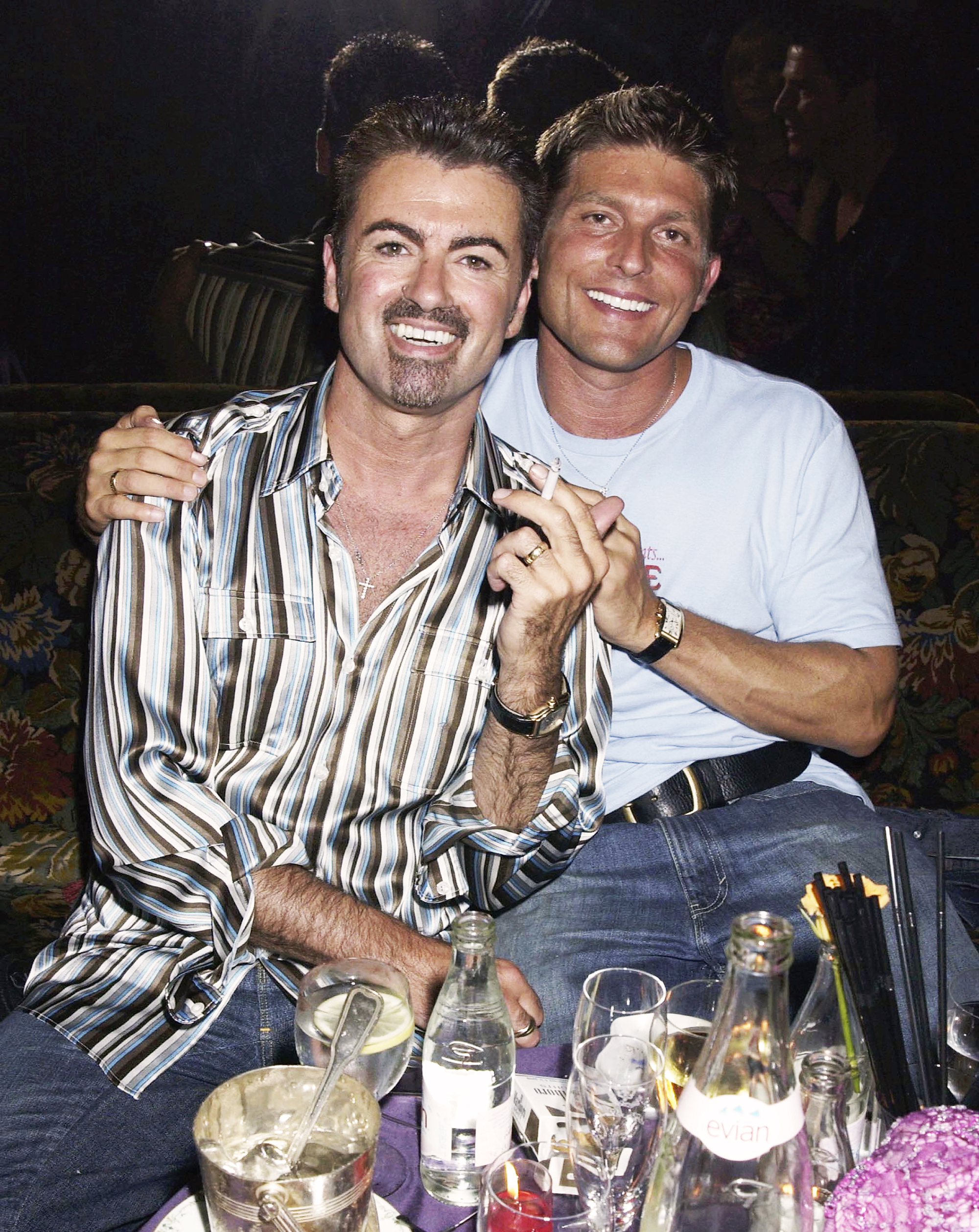 George Michael and partner Kenny Goss at the Versace Couture launch party in Paris, on July 9, 2002.