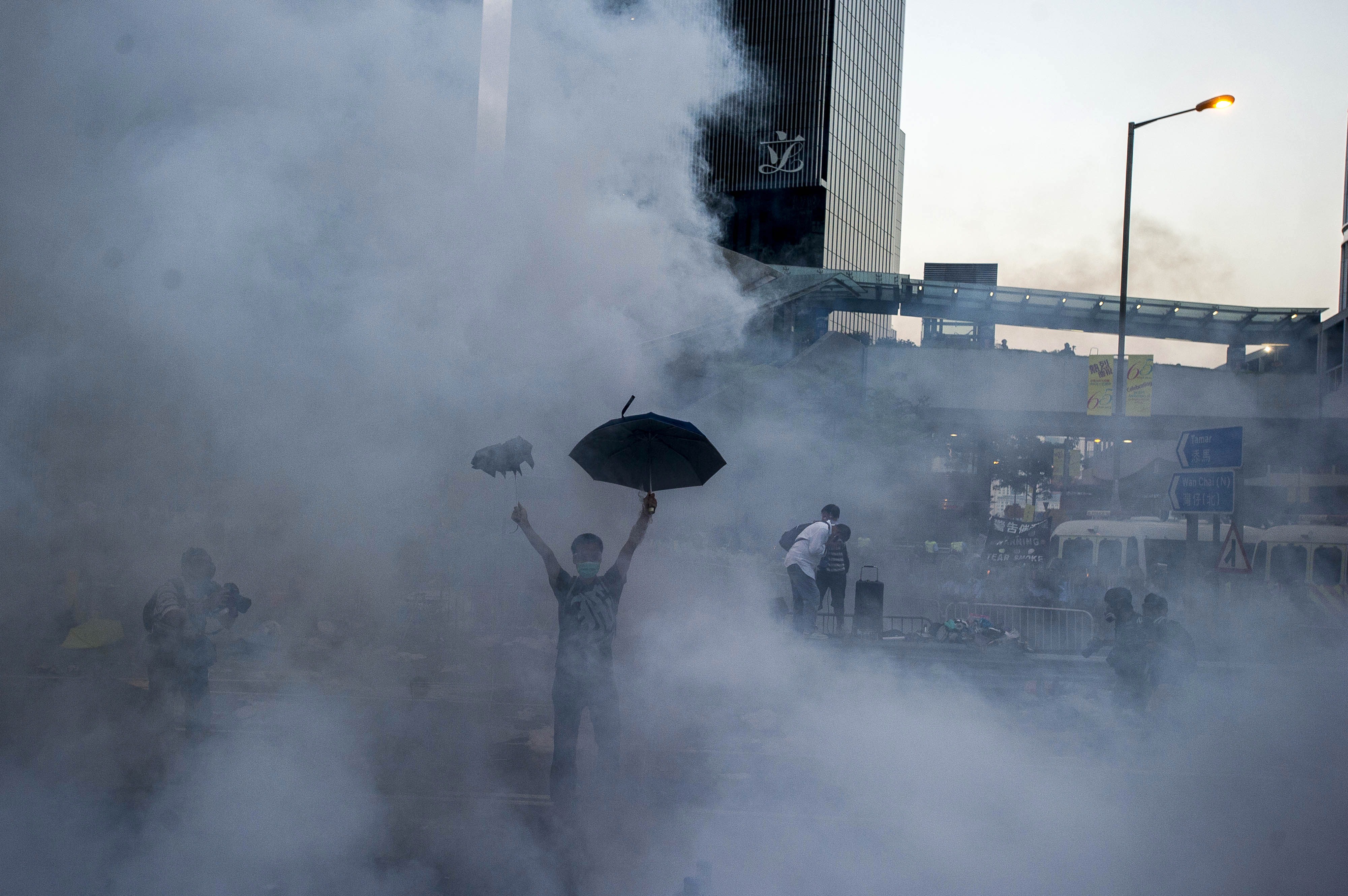 A pro-democracy demonstrator holds a defiant umbrella aloft after police fire tear gas near the Hong Kong government headquarters in Hong Kong on Sept. 28, 2014 (Xaume Olleros—AFP/Getty Images)