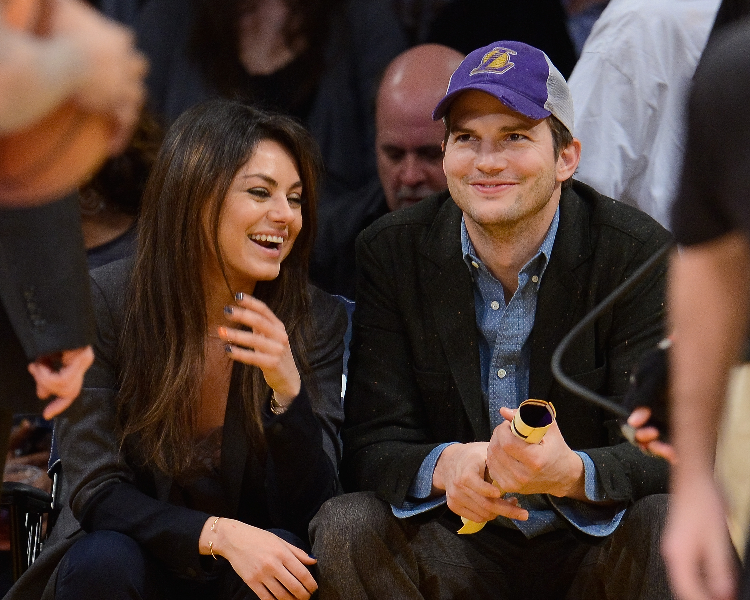 Ashton Kutcher (R) and Mila Kunis attend a basketball game at Staples Center on Jan. 3, 2014 in Los Angeles, California. (Noel Vasquez—Getty Images)