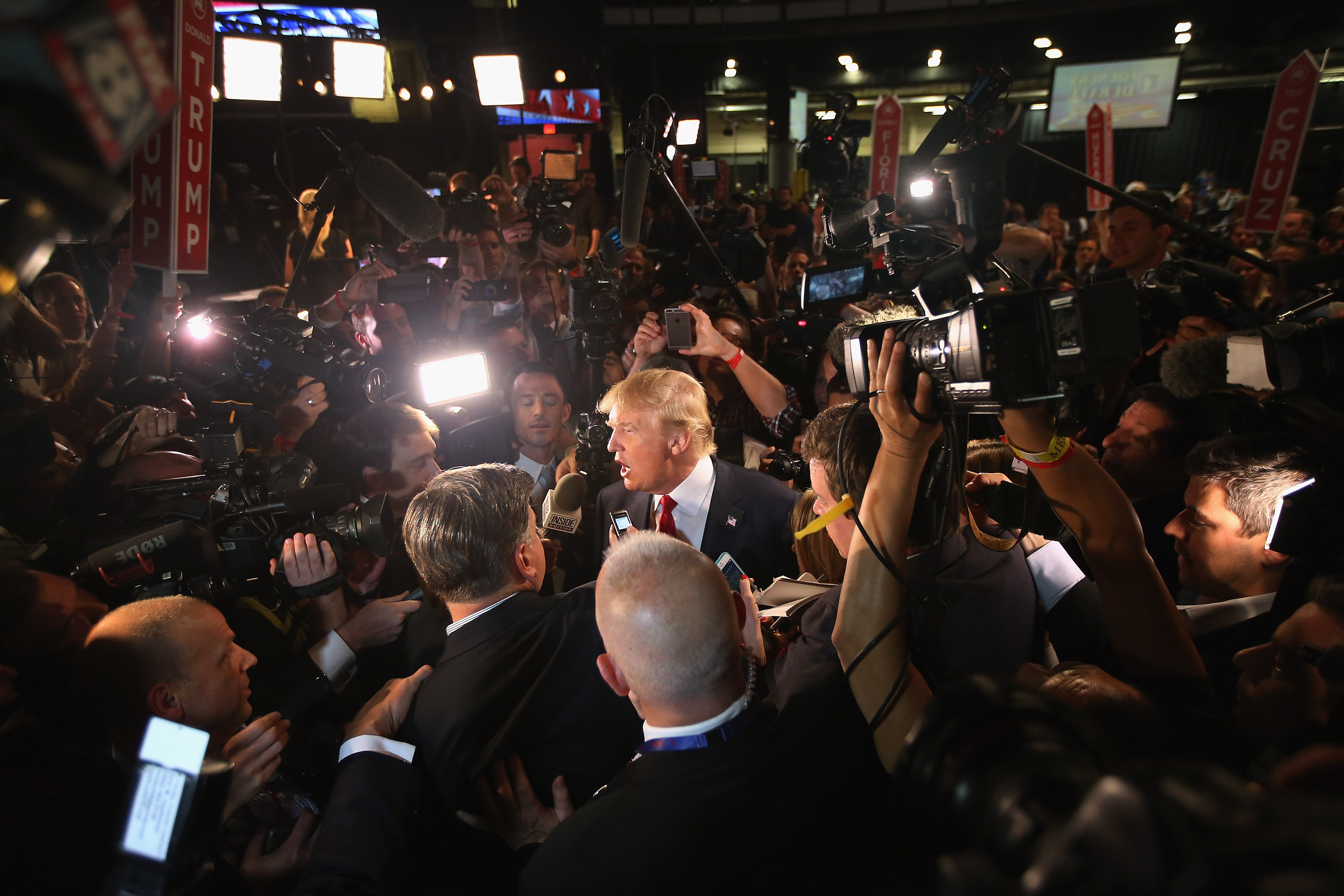 Republican presidential candidate Donald Trump (C) talks to reporters in the 'Spin Alley' after the first prime-time presidential debate hosted by FOX News and Facebook at the Quicken Loans Arena on Aug. 6, 2015 in Cleveland. (Scott Olson—Getty Images)