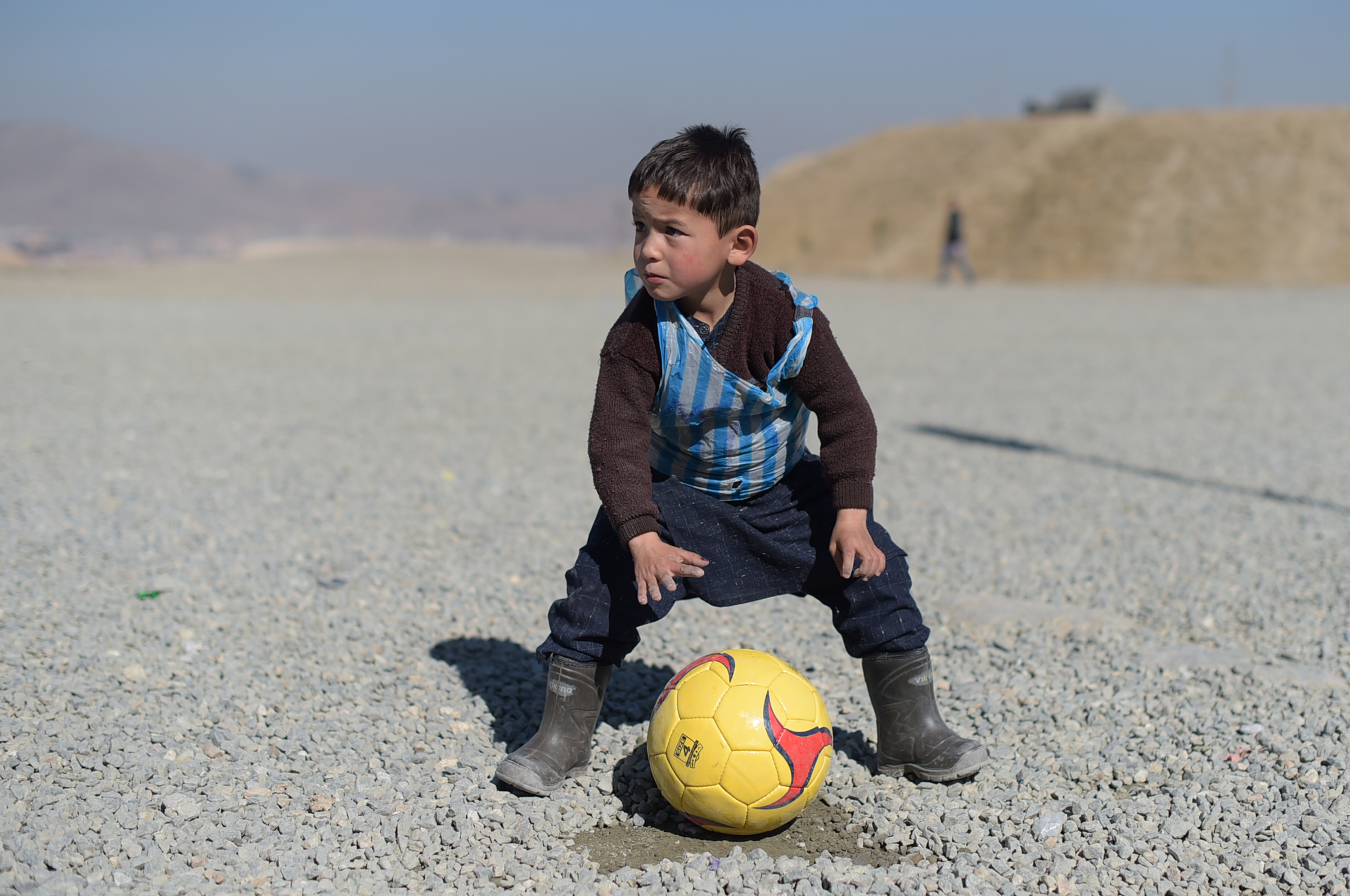 Murtaza Ahmadi, a young Lionel Messi fan, plays football in Kabul on Feb. 1, 2016 (Shah Marai—AFP/Getty Images)