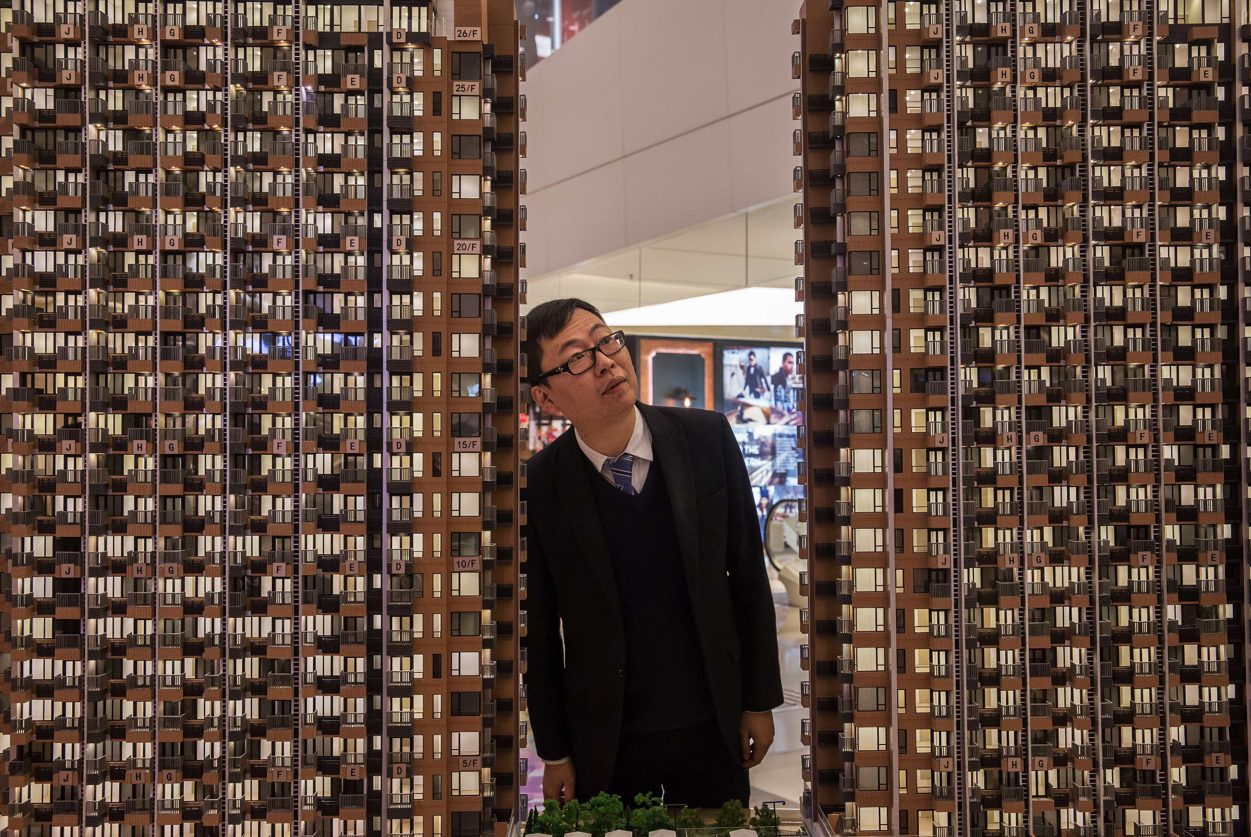 A man looks at a model of Park Vista, a residential property developed by Sun Hung Kai Properties, at a sales exhibition in Hong Kong, on Feb. 3, 2016 (Bloomberg/Getty Images)