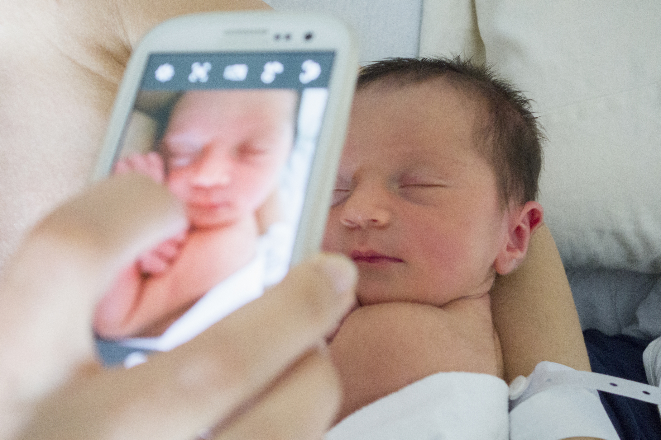 USA, New York, New York City, Mother photographing newborn daughter
