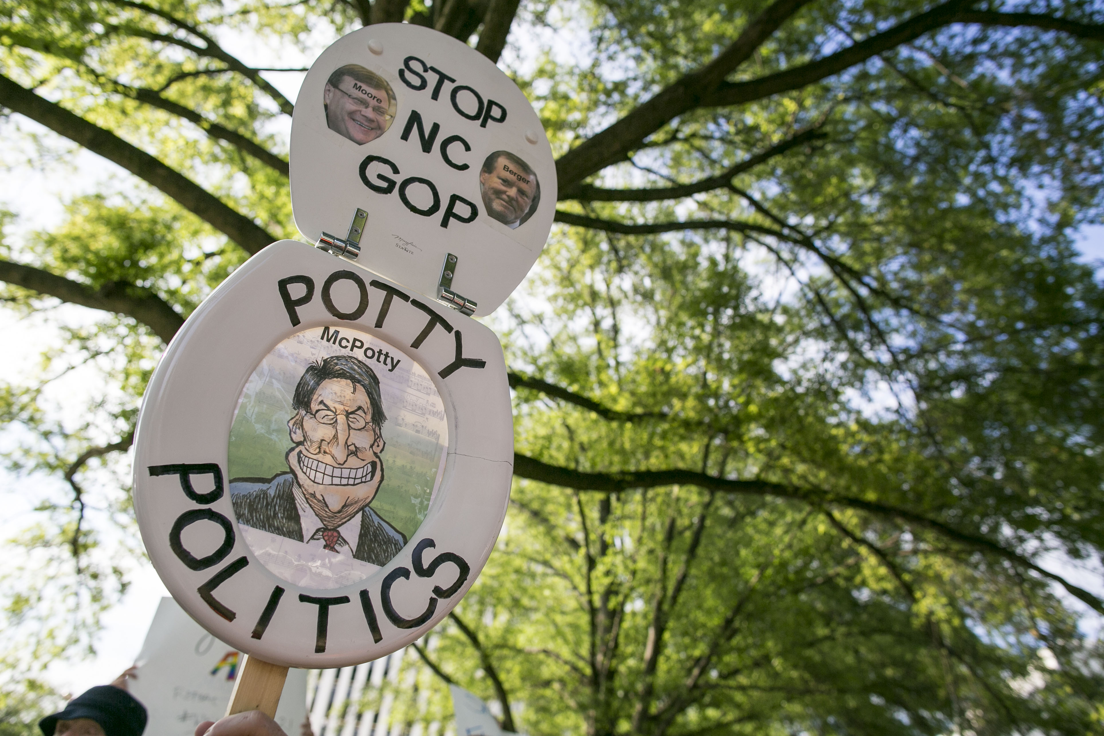 Protestors gather across the street from the North Carolina state legislative building as they voice their concerns over House Bill 2, in Raleigh, N.C., Monday, May 16, 2016. (Al Drago—CQ-Roll Call/AP)