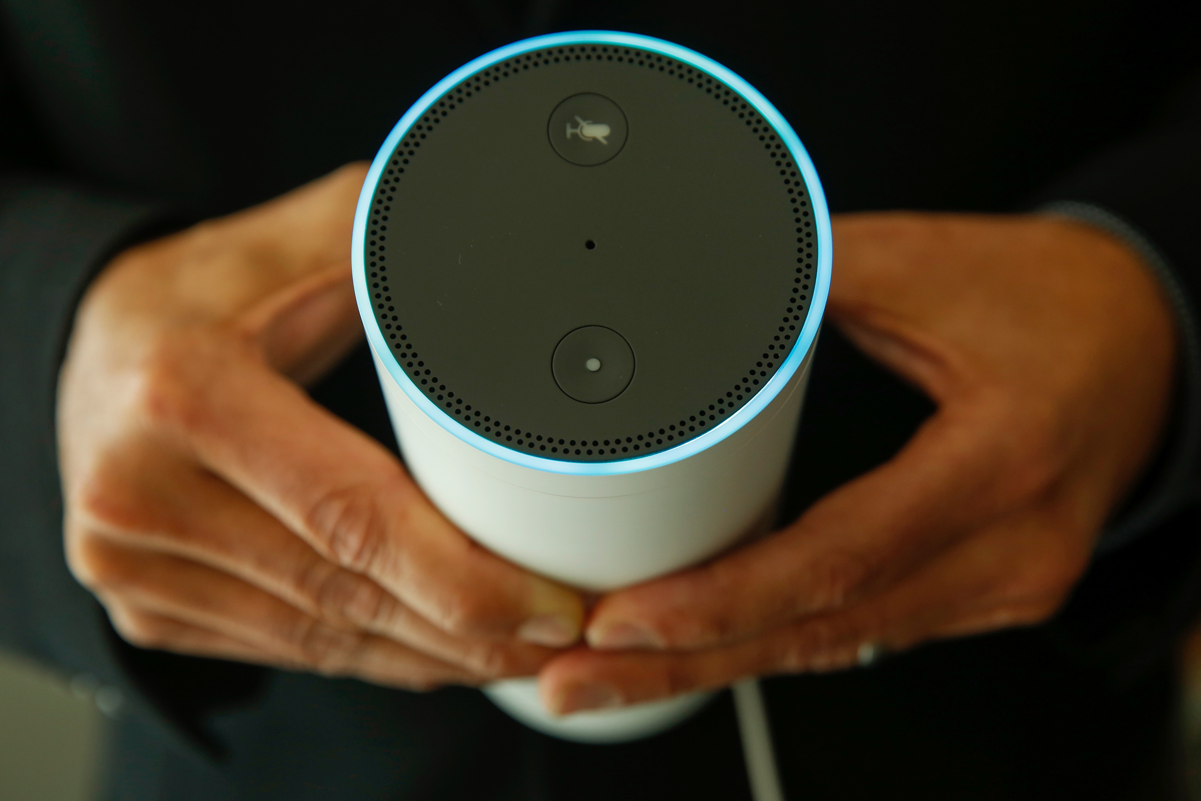 An attendee holds an Echo device during the U.K. launch event for the Amazon.com Inc. Echo voice-controlled home assistant speaker in this arranged photograph in London, U.K., on Wednesday, Sept. 14, 2016. (Bloomberg&mdash;Bloomberg via Getty Images)