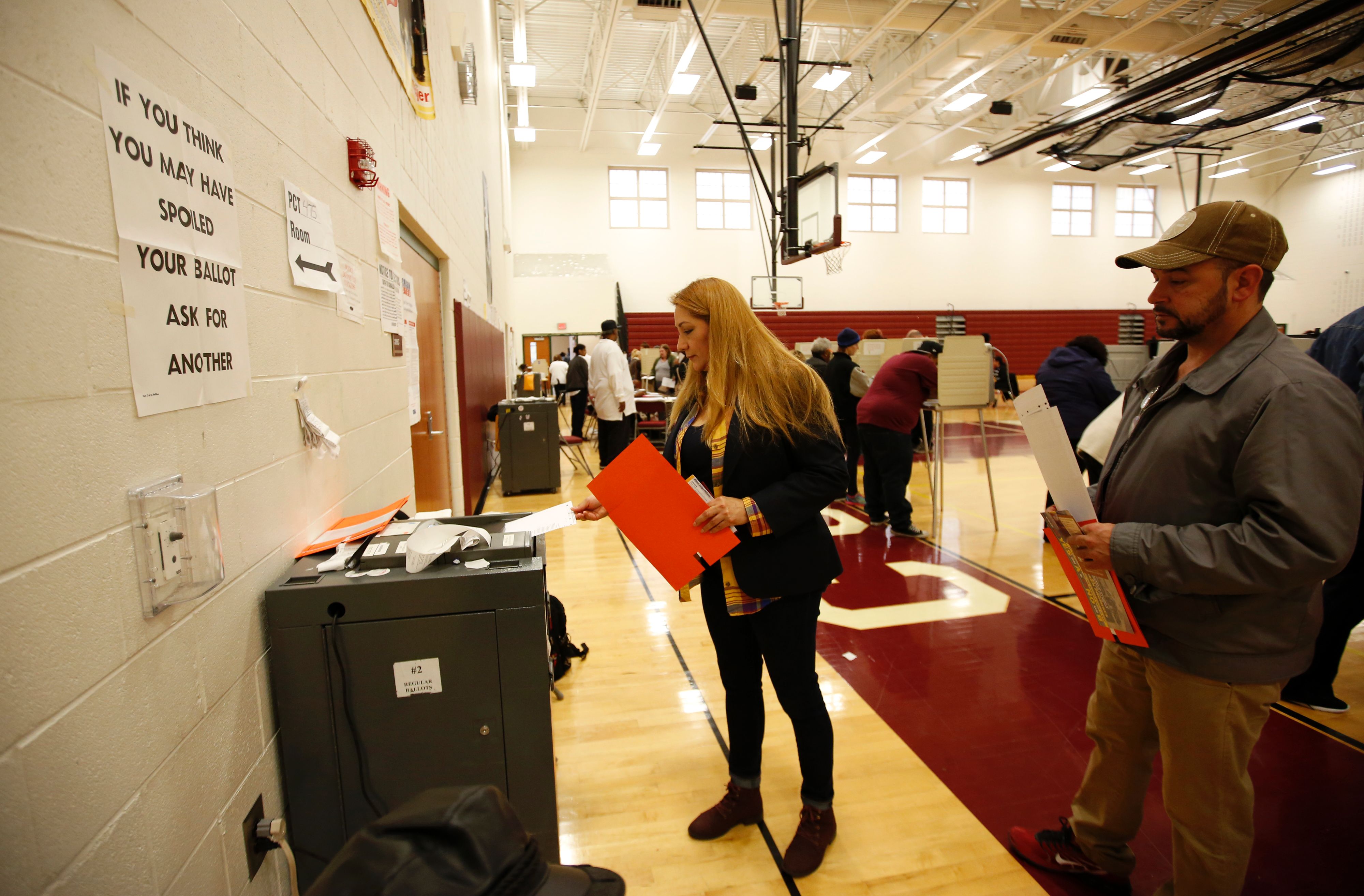 A woman places her ballot in the tabulation machine after voting at Western High School  School in the US presidential election on November 8, 2016 in Detroit, Michigan.      (JEFF KOWALSKY--AFP/Getty Images) (JEFF KOWALSKY—AFP/Getty Images)