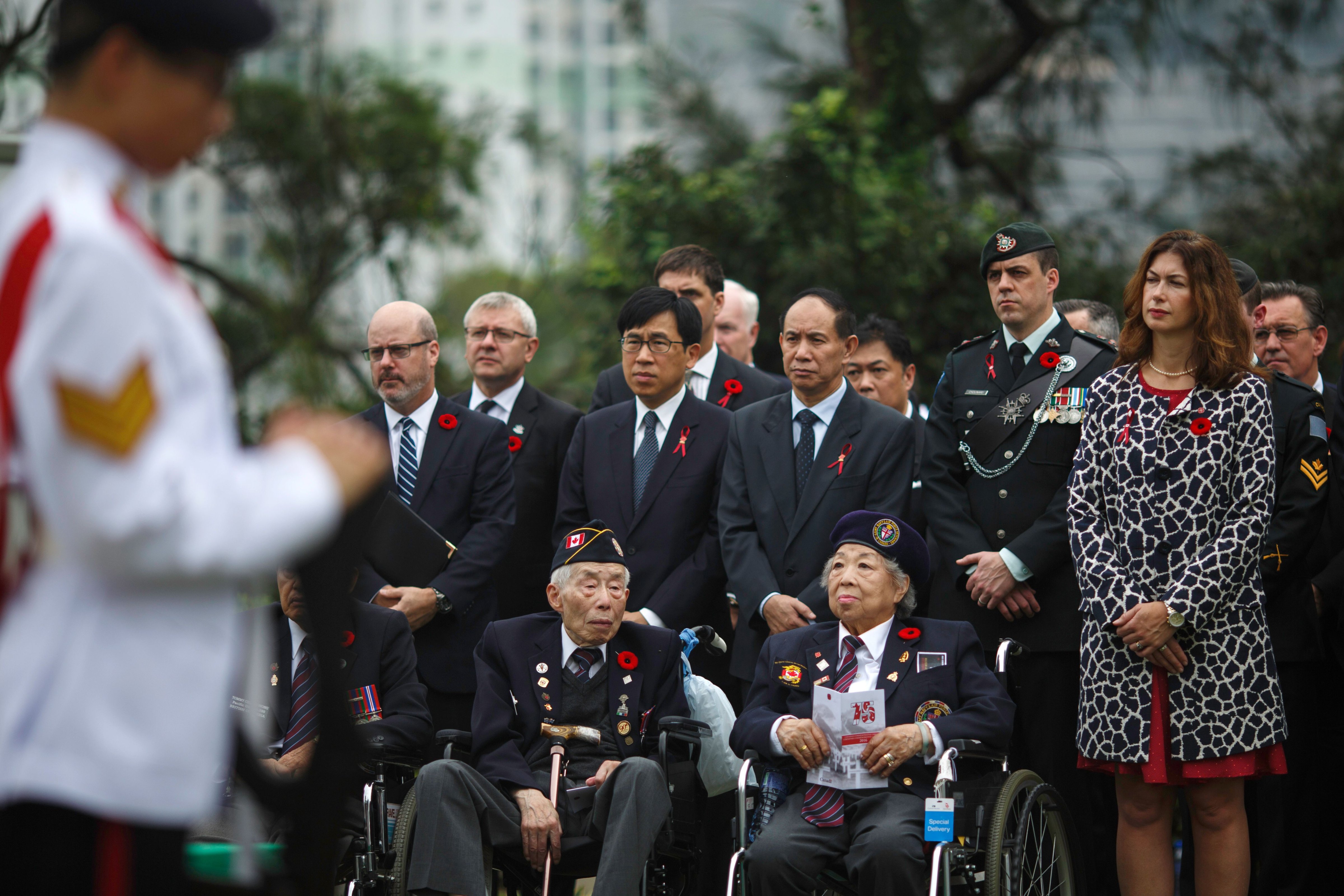 Hong Kong World War II veterans, front row, and attendees, including relatives of World War II veterans, attend the Canadian commemorative ceremony in Hong Kong's Sai Wan War Cemetery on Dec. 4, 2016, honoring those who died during the Battle of Hong Kong and World War II (Tengku Bahar—AFP/Getty Images)