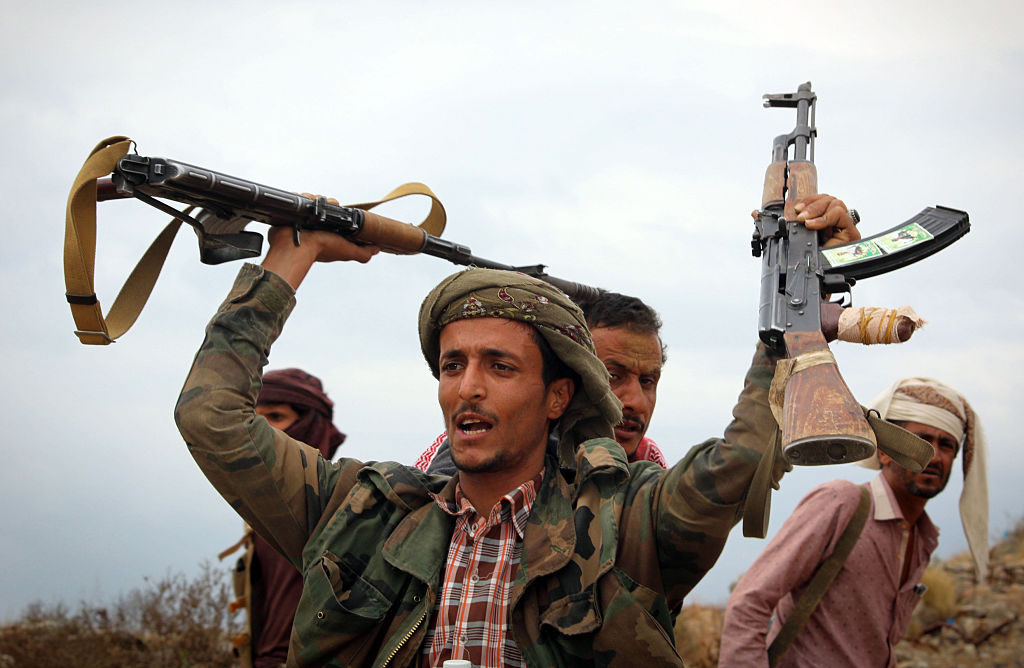 A Yemeni tribesman from the Popular Resistance Committee, supporting forces loyal to Yemen's Saudi-backed President Abedrabbo Mansour Hadi, raises weapons during clashes with Shiite-Huthi rebels in the country's third-city of Taez on December 19, 2016. / AFP / Ahmad AL-BASHA        (Photo credit should read AHMAD AL-BASHA/AFP/Getty Images) (AHMAD AL-BASHA&mdash;AFP/Getty Images)