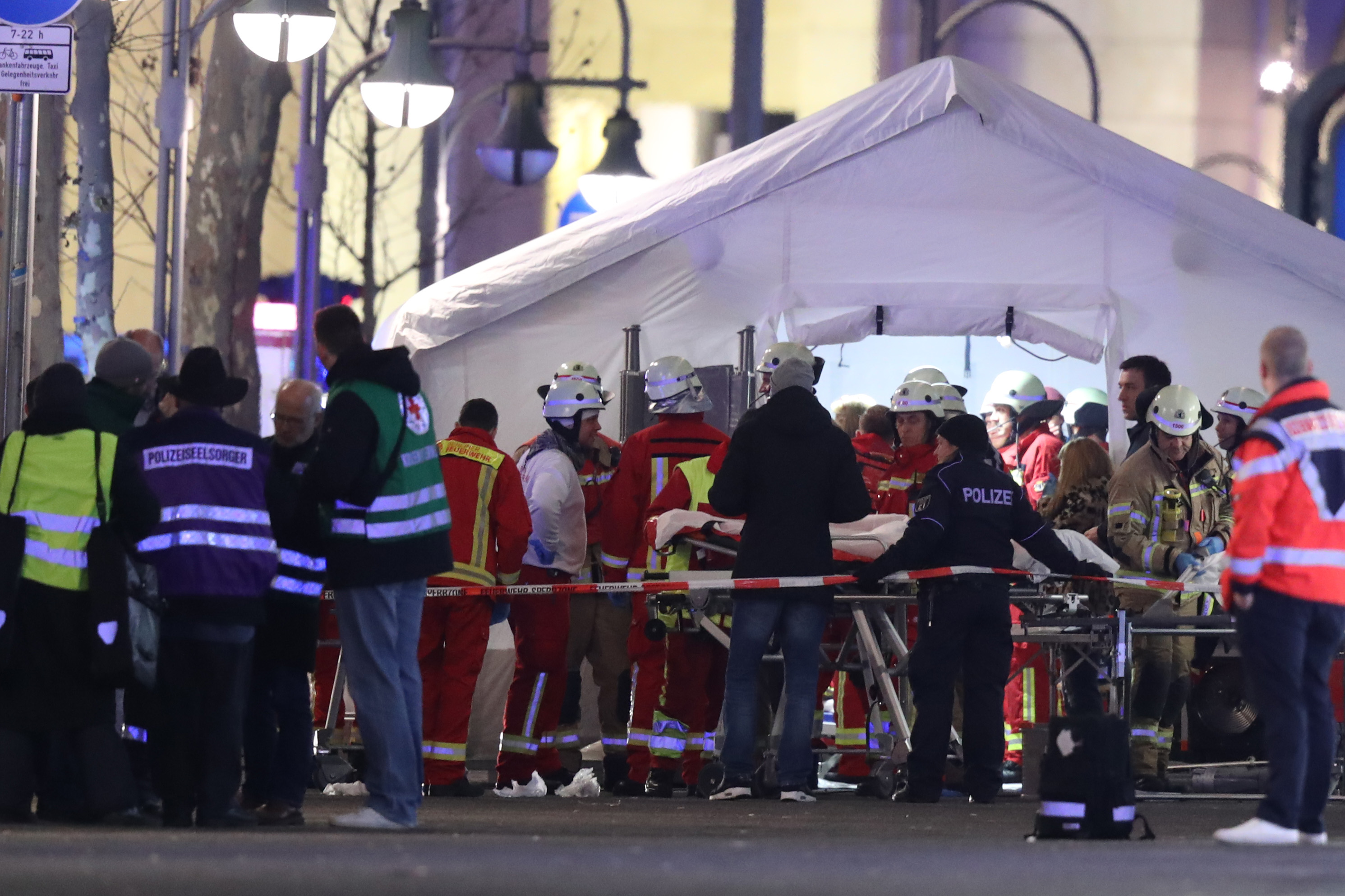 Rescue workers gather with stretchers outside a tent in the area after a lorry plowed through a Christmas market on December 19, 2016 in Berlin, Germany. (Sean Gallup—Getty Images)