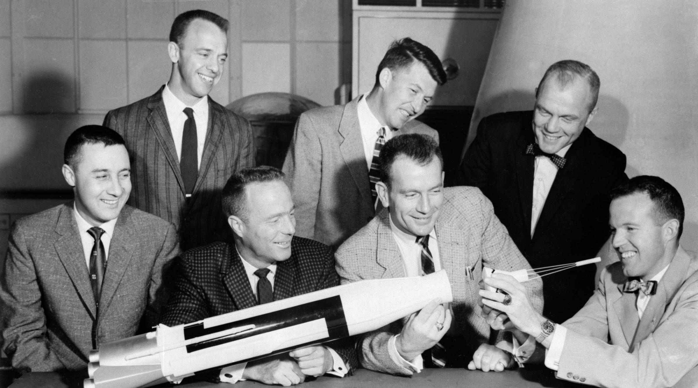 The Magnificent Seven The original seven Mercury astronauts examine a rough model of the Mercury-Atlas rocket in 1959. Back row, from left: Al Shepard, Wally Schirra and John Glenn; front row, from left: Gus Grissom, Scott Carpenter, Deke Slayton and Gordon Cooper.