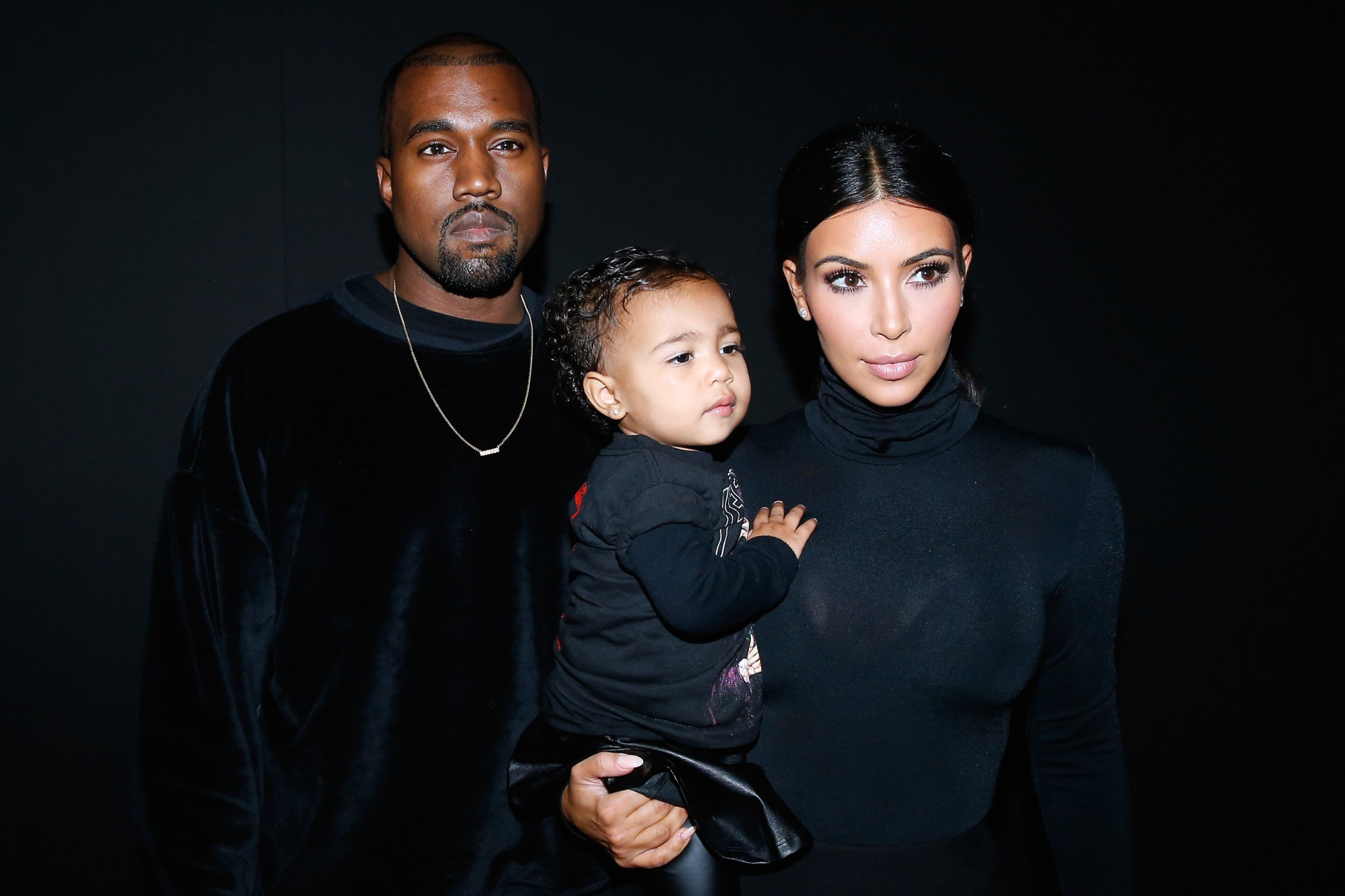 Kanye West, Kim Kardashian and their daughter North West attend the Balenciaga show as part of the Paris Fashion Week Womenswear Spring/Summer 2015 on September 24, 2014 in Paris, France.