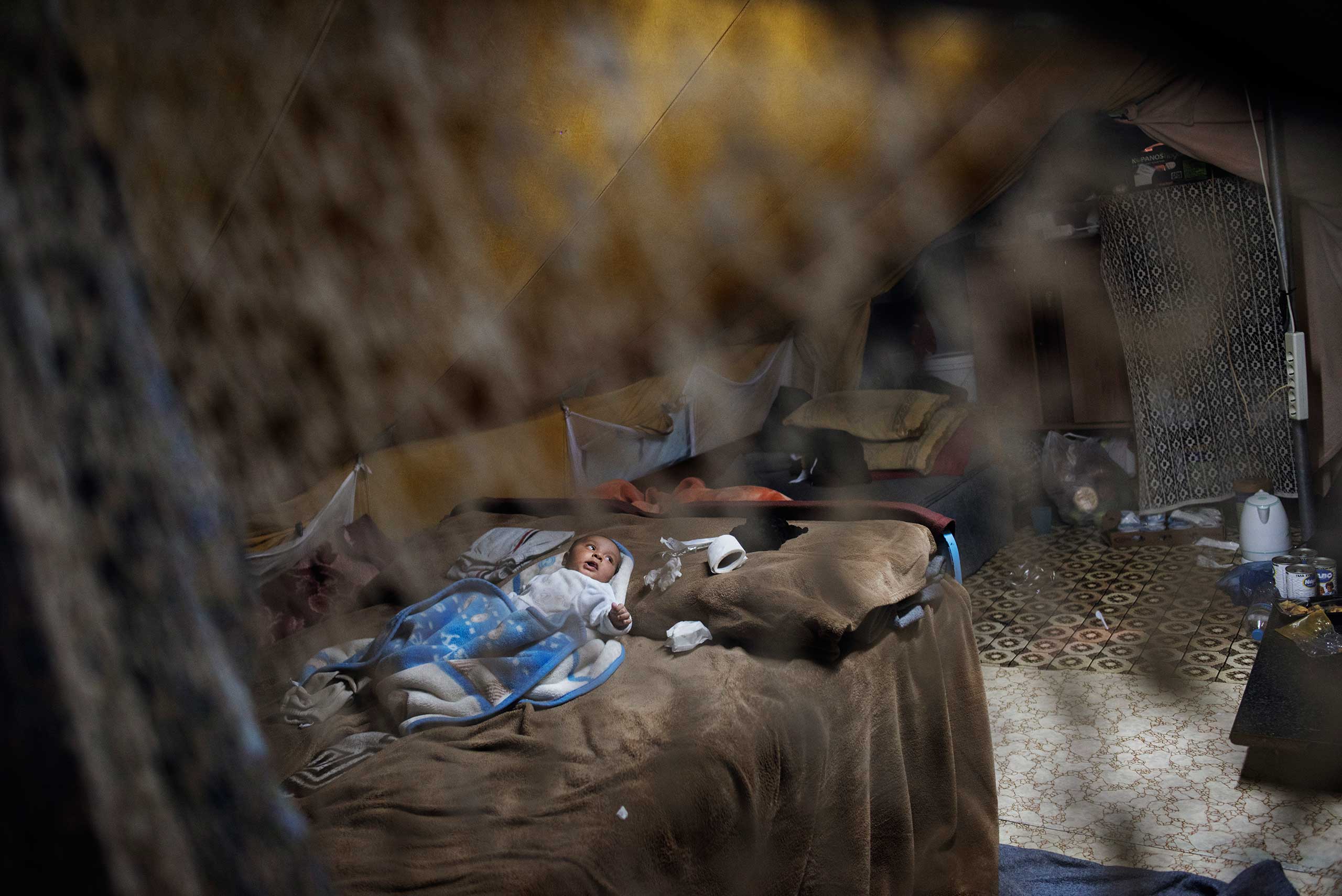 Baby Faraj, nicknamed Hamoudi, was born Oct. 2, 2016. He lies in a  tent in the Oreokastro refugee camp, Thessaloniki, Greece, Nov. 9, 2016. He is the youngest of five sons born to Ilham Alarabi, 23, and her husband, Minhel,  from Deir ez-Zor, Syria.
