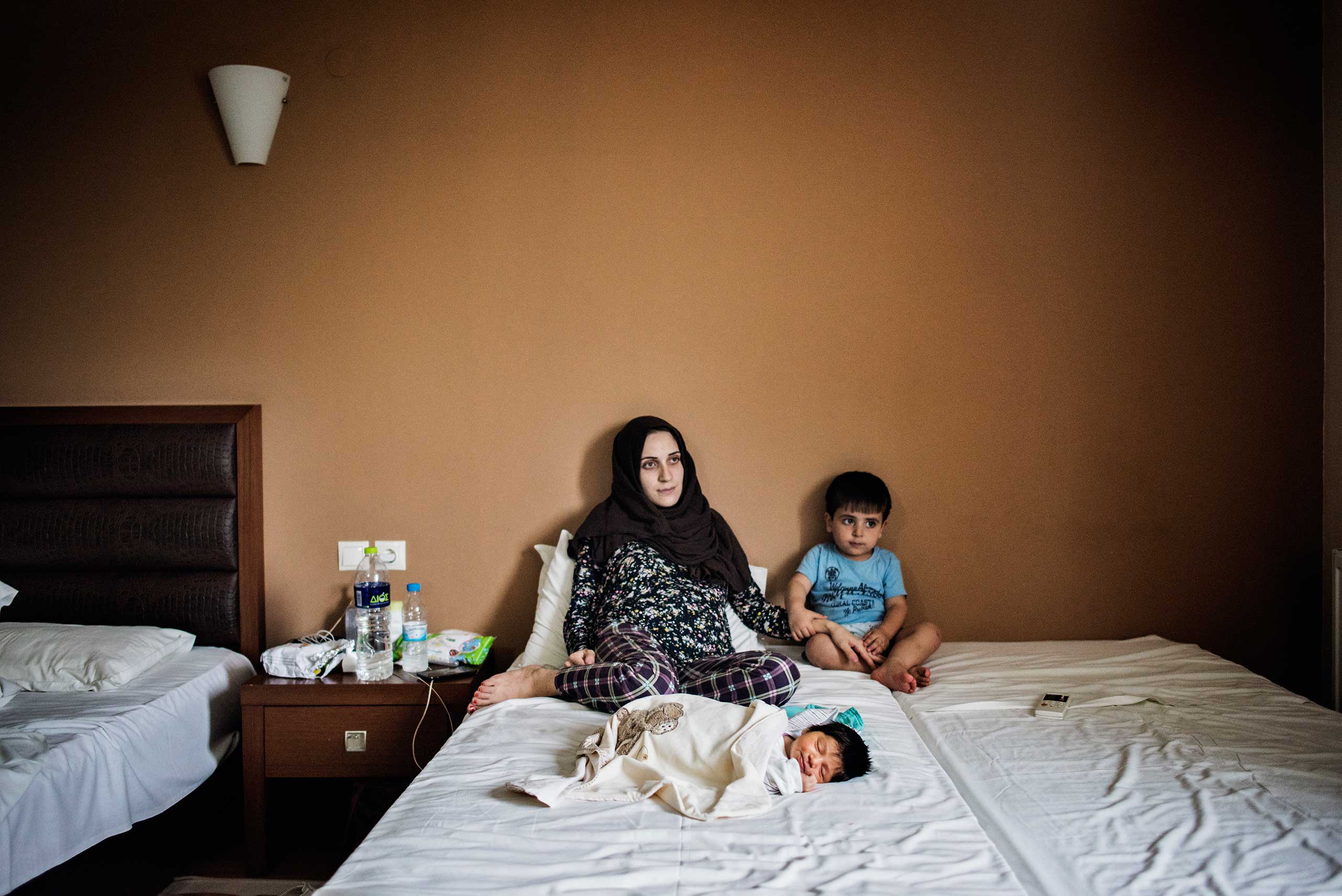 Taimaa Abazli, 24, with her newborn daughter, Heln, born by C-section on Sept. 13 at a hotel outside Thessaloniki, Greece.   Her first child, Wael, sits with them.
                              Taimaa and her husband, Muhannad 28, are from Idlib, Syria, near the border with Turkey, Sept. 19, 2016.