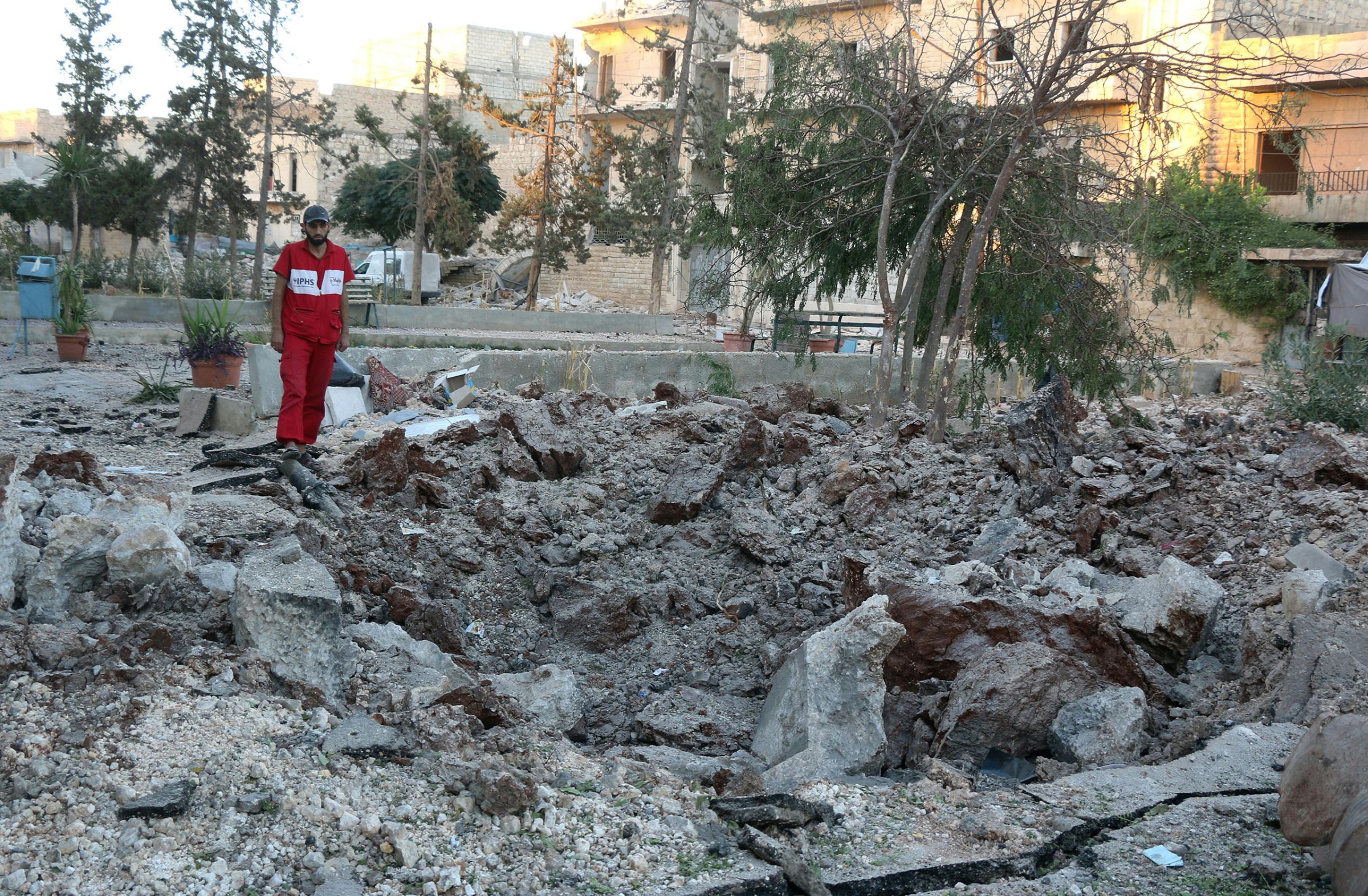 A Syrian medical staff member inspects the damage at the site of a medical facility after it was reportedly hit by Syrian regime barrel bombs on Oct. 1, 2016, in the rebel-held neighbourhood of al-Sakhour, in the northern city of Aleppo.