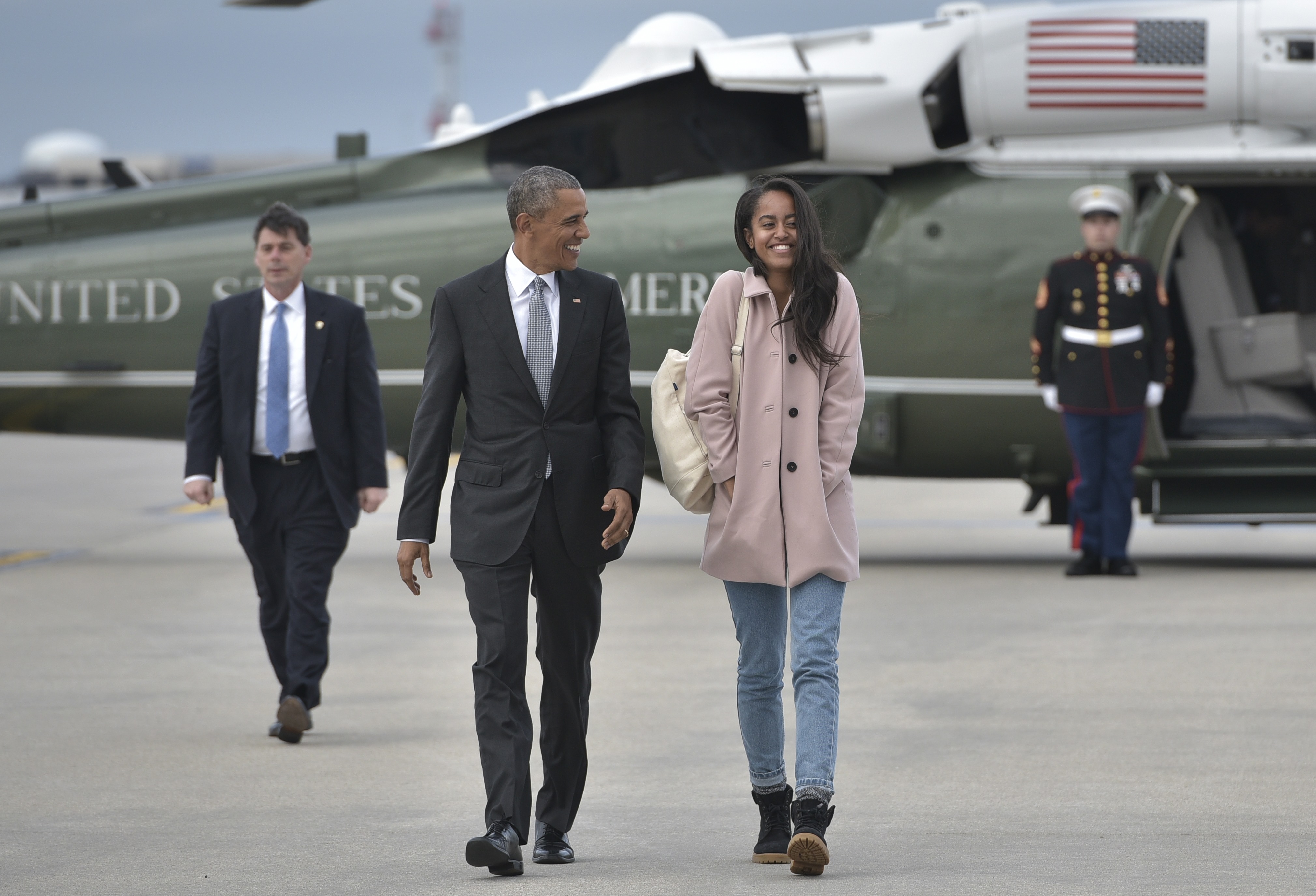 US President Barack Obama and daughter Malia make their way to board Air Force One before departing from Chicago OHare International Airport in Chicago on April 7, 2016. Obama is heading to Los Angeles to attend fundraisers. / AFP / MANDEL NGAN        (Photo credit should read MANDEL NGAN/AFP/Getty Images) (MANDEL NGAN&mdash;AFP/Getty Images)