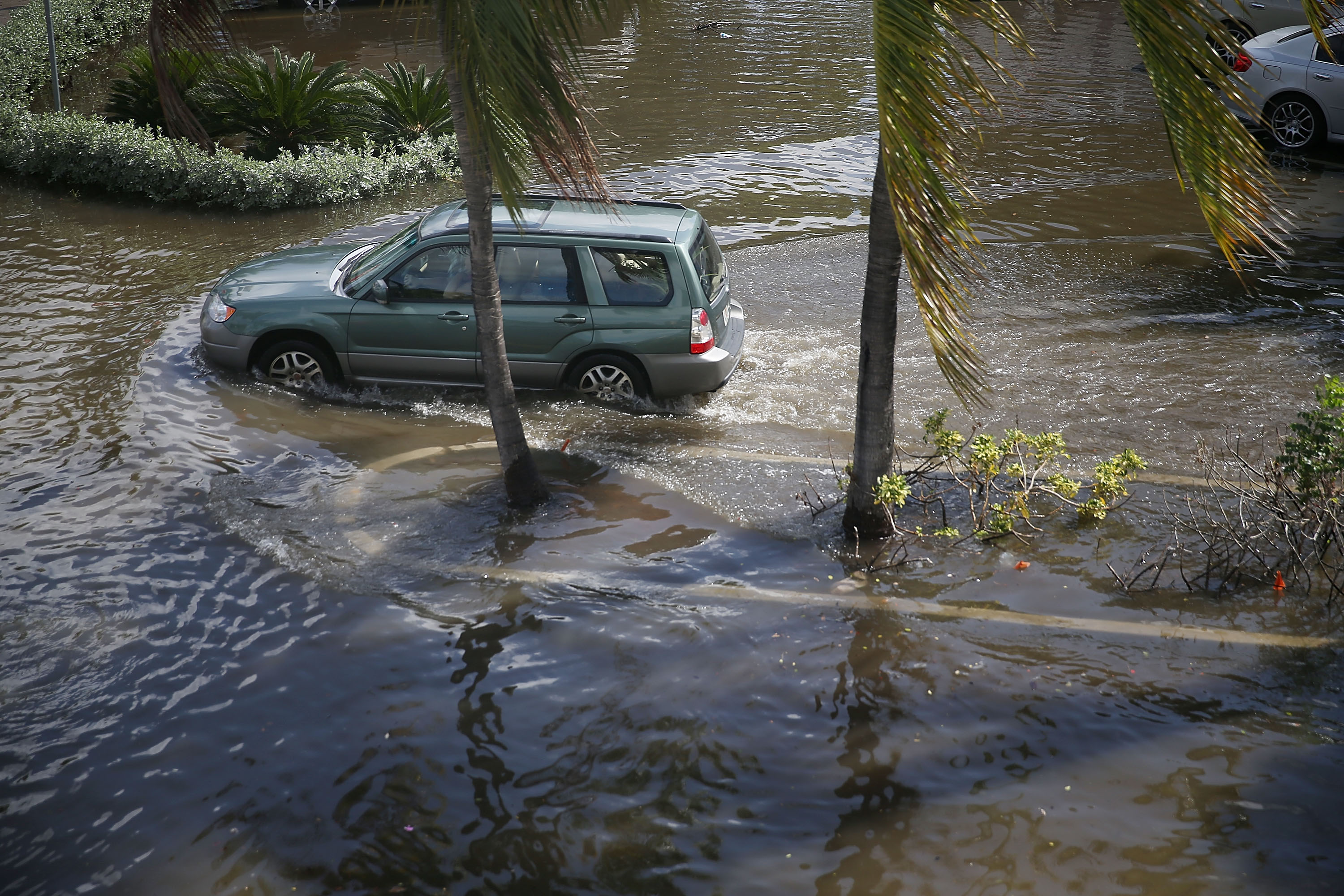 A vehicle drives through flooded streets caused by the combination of the lunar orbit, which caused seasonal high tides, and rising sea levels due to climate change on September 30, 2015 in Fort Lauderdale, Florida. (Joe Raedle&mdash;Getty Images)